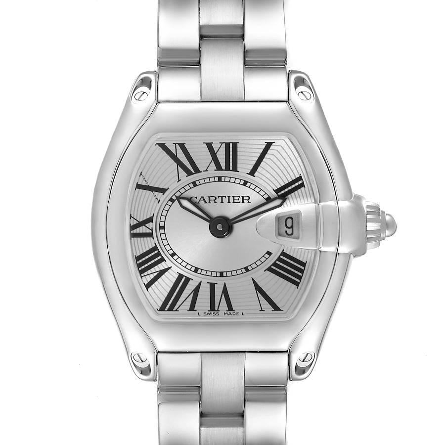 The Cartier Roadster watch is shown from a front angle, highlighting the face, Roman numerals, and metal bracelet.