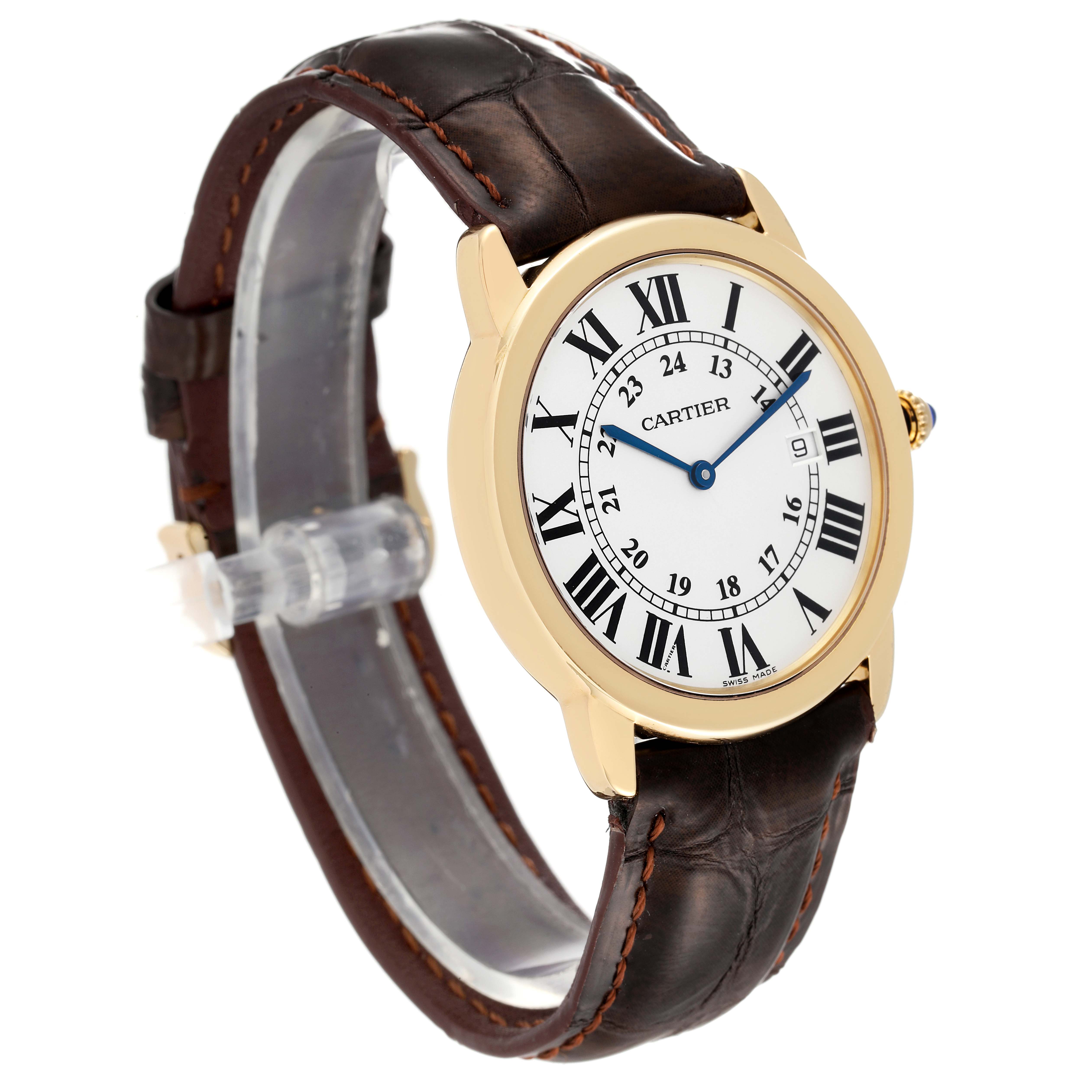 The image shows a Cartier Ronde W6700455 Men
s Yellow Gold Silver Dial W6700455 Men
s Yellow Gold Silver Dial watch at a tilted angle, highlighting its round face, Roman numerals, and brown leather strap.