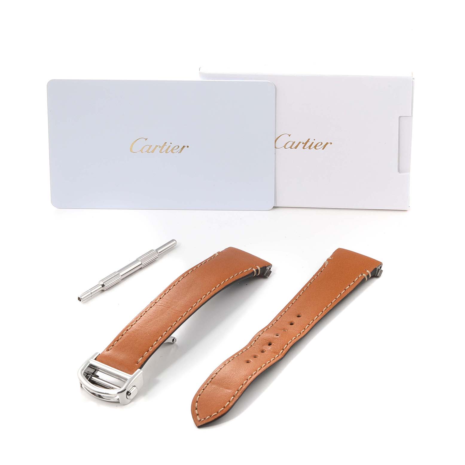 The image shows tan leather straps, a tool, and packaging for a Cartier Santos WSSA0029 Men
s Stainless Steel Silver Dial WSSA0029 Men
s Stainless Steel Silver Dial watch.