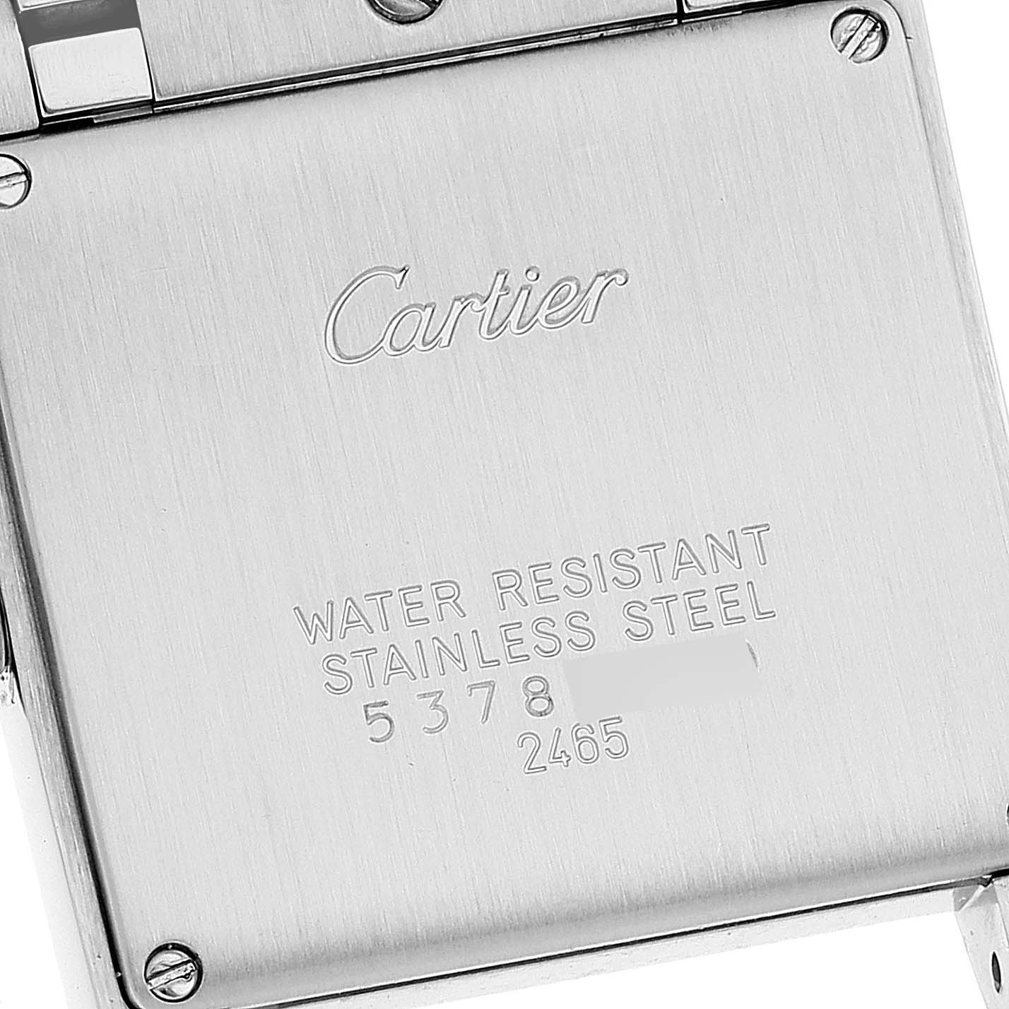 The image shows the back case of a Cartier Tank Francaise W51011Q3 Men's Stainless Steel Silver Dial W51011Q3 Men's Stainless Steel Silver Dial watch with engraved details and metal screws.