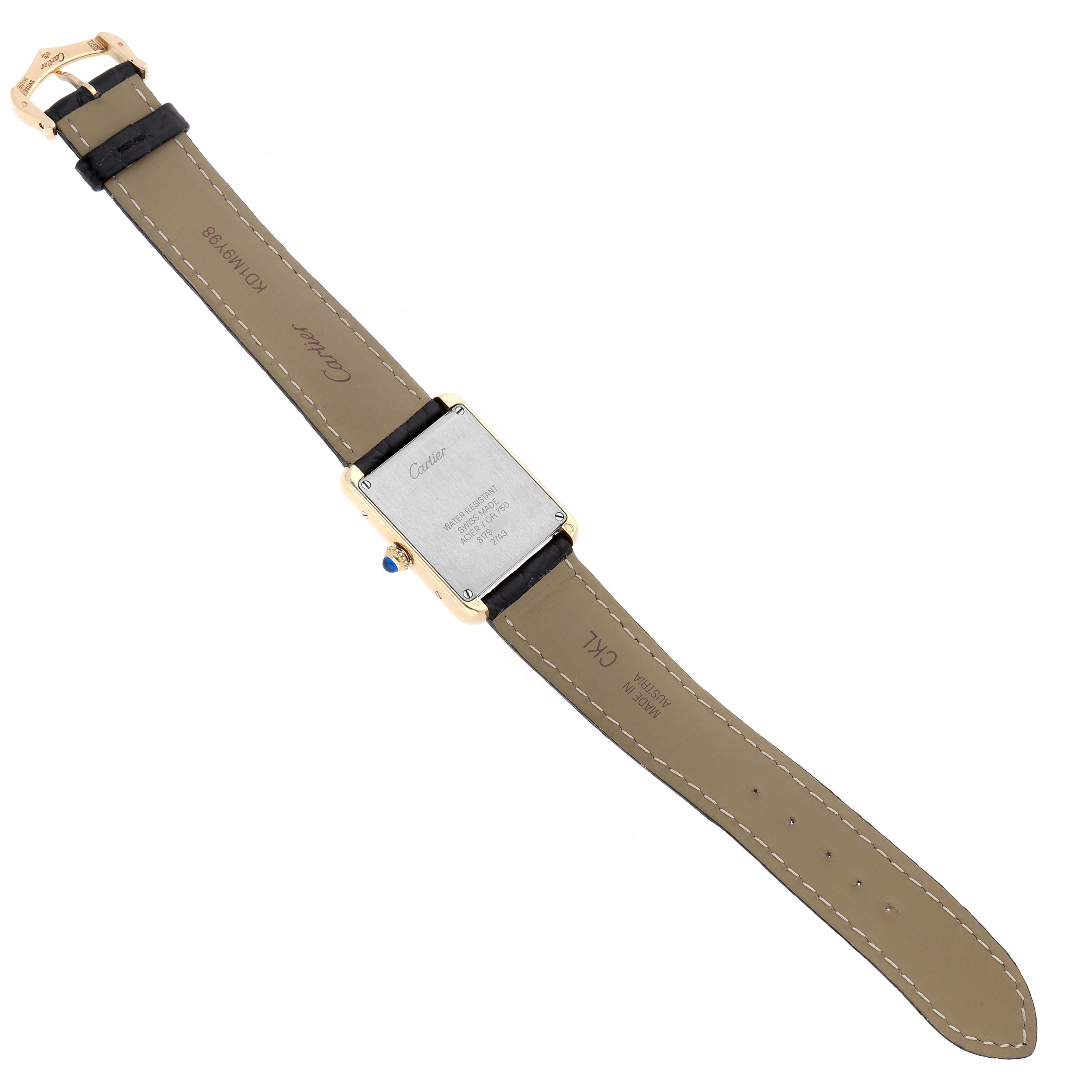 The Cartier Tank Solo W1018755 Women's Steel and Gold (two tone) Silver Dial watch is shown from the back, highlighting its case back, strap, and clasp.