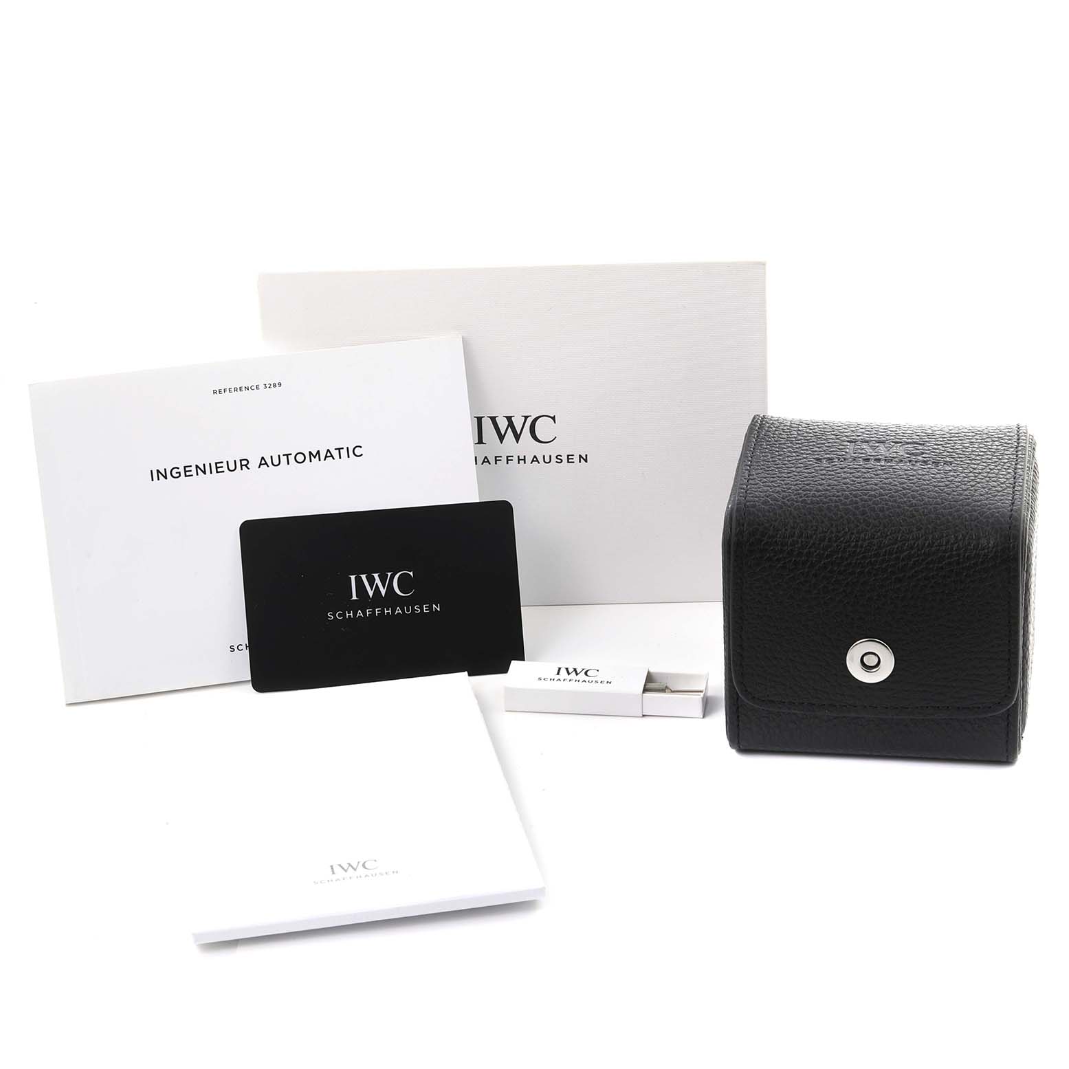 The image shows IWC Ingenieur IW328901 Men's Stainless Steel Black Dial IW328901 Men's Stainless Steel Black Dial watch accessories including manuals, a warranty card, and a leather case from a frontal angle.