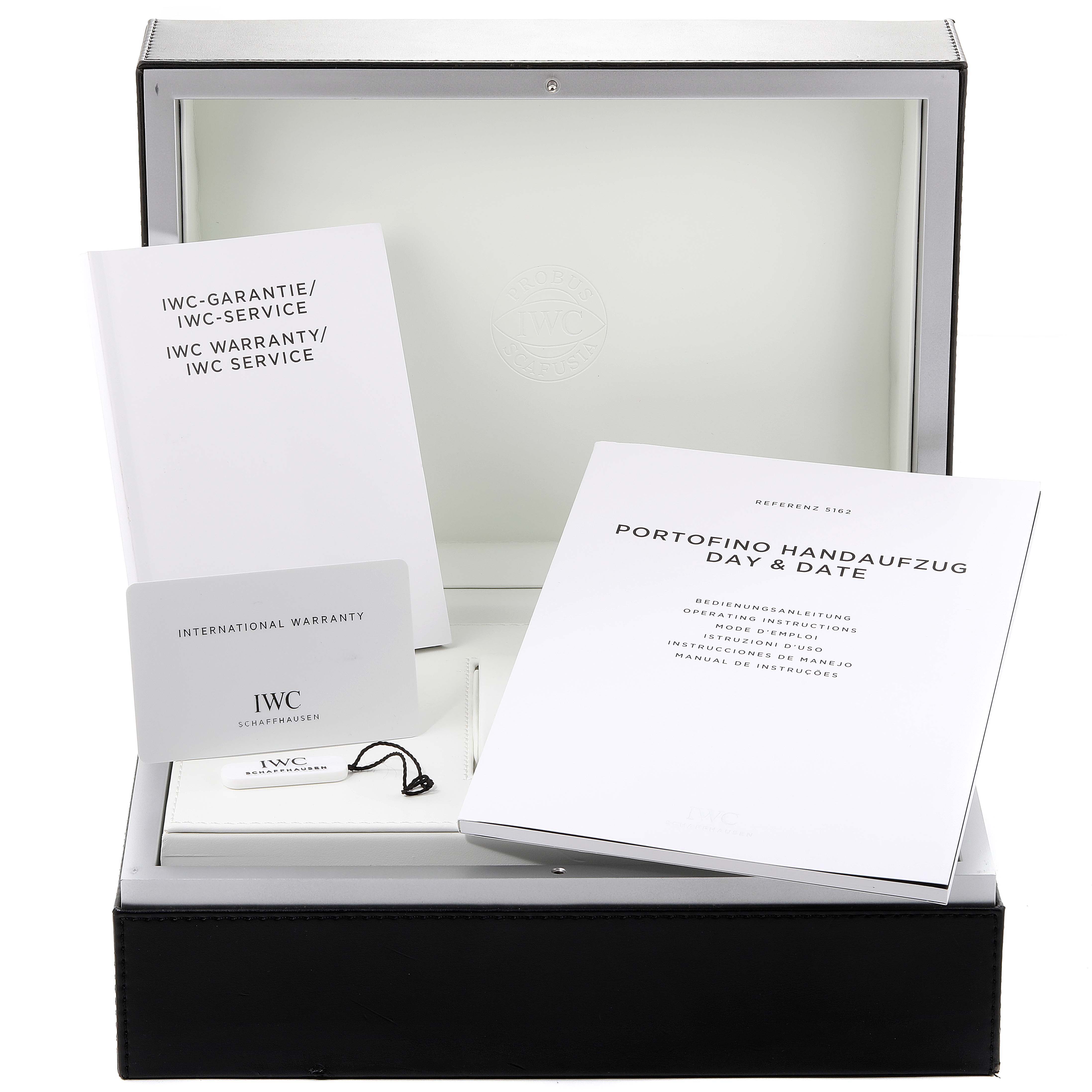 The image shows the packaging and accessories for the IWC Portofino IW516201 Men's Stainless Steel Silver Dial IW516201 Men's Stainless Steel Silver Dial watch, including manuals and an international warranty card.