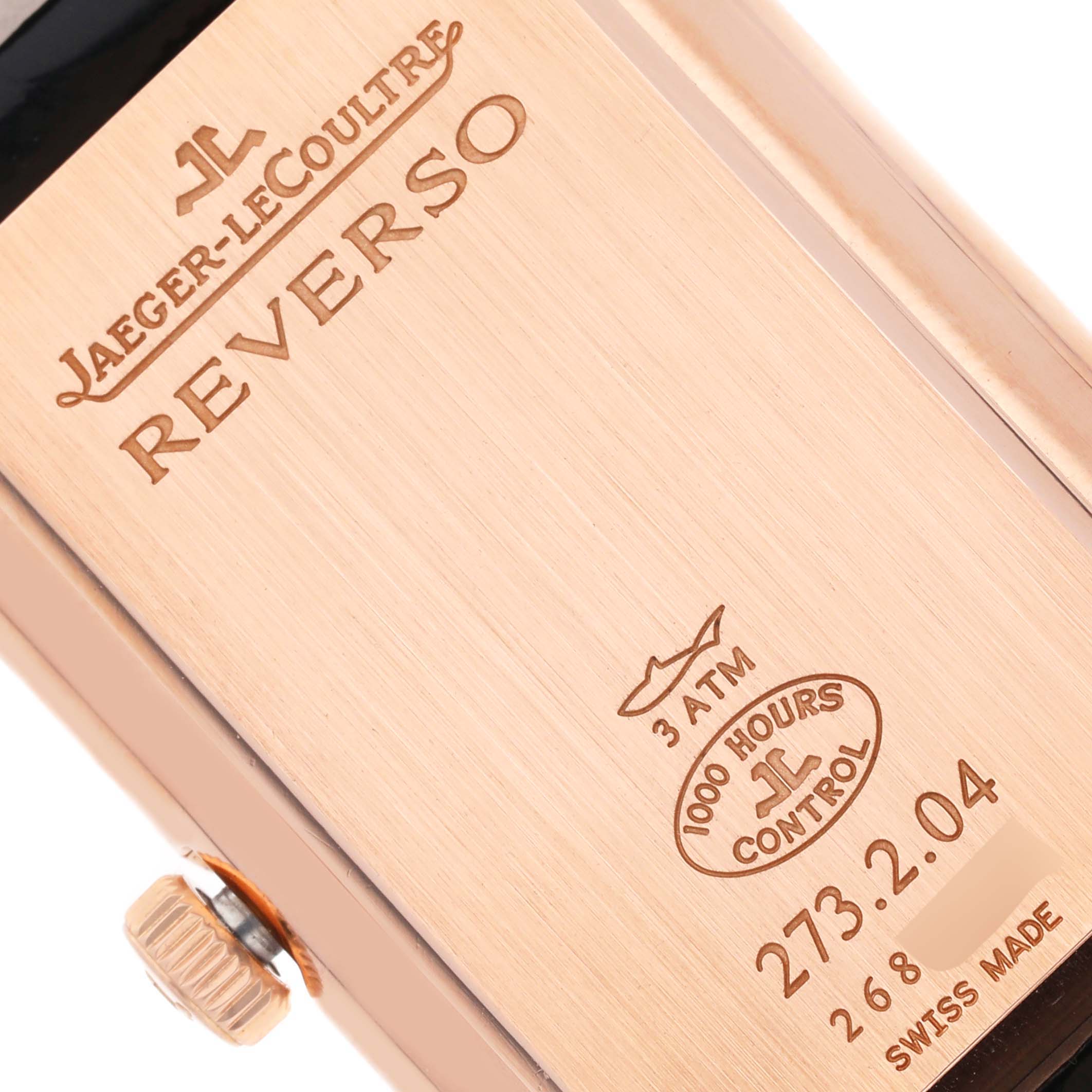 The image shows the engraved back of a Jaeger-LeCoultre Reverso watch, highlighting water resistance and control marks.