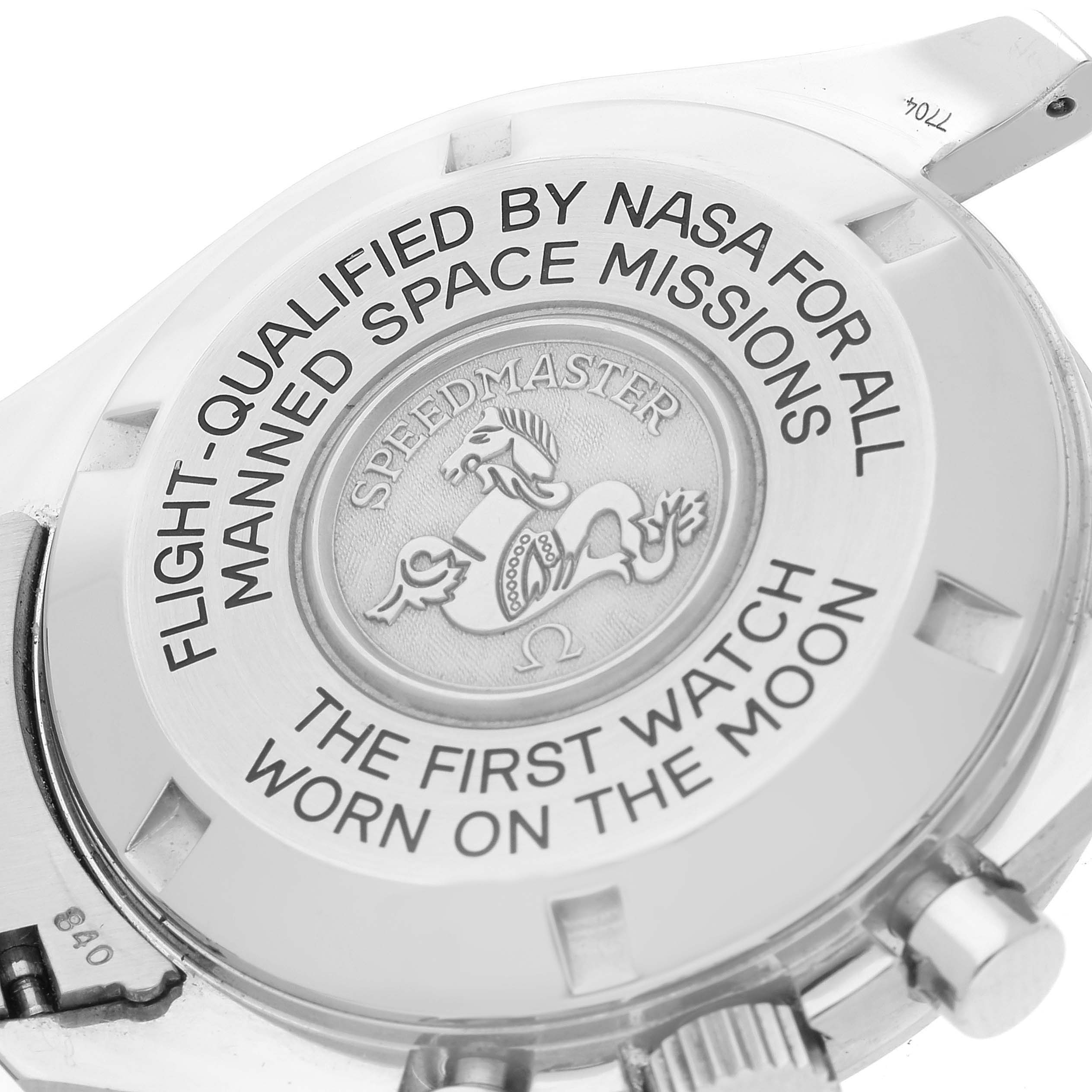 The image shows the case back of an Omega Speedmaster 3575.20.00 Men's Stainless Steel White Dial 3575.20.00 Men's Stainless Steel White Dial watch with engraved text and logo.