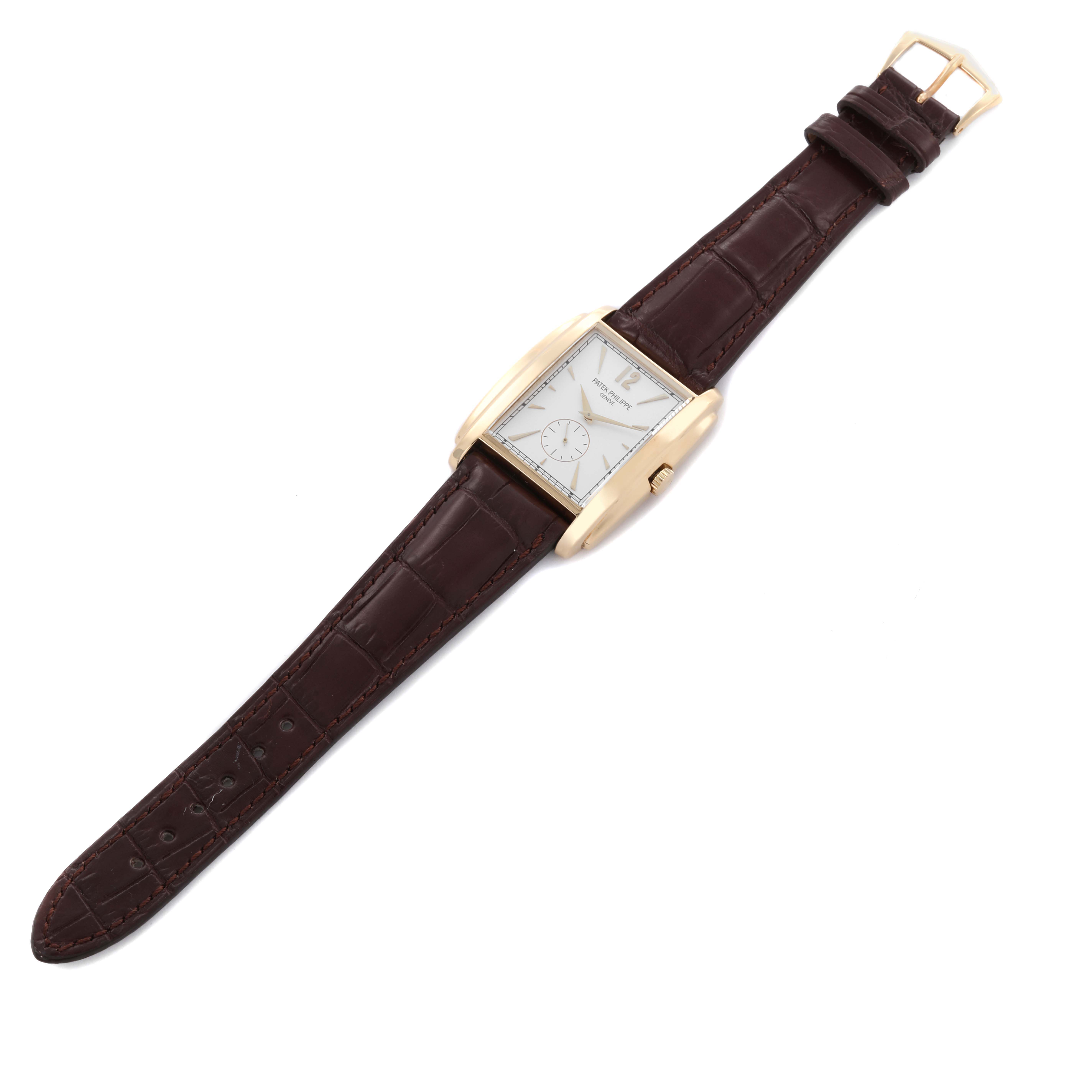 The Patek Philippe Gondolo 5124J Men's Yellow Gold Silver Dial 5124J Men's Yellow Gold Silver Dial watch is shown at a slight diagonal, displaying the face, strap, and buckle.