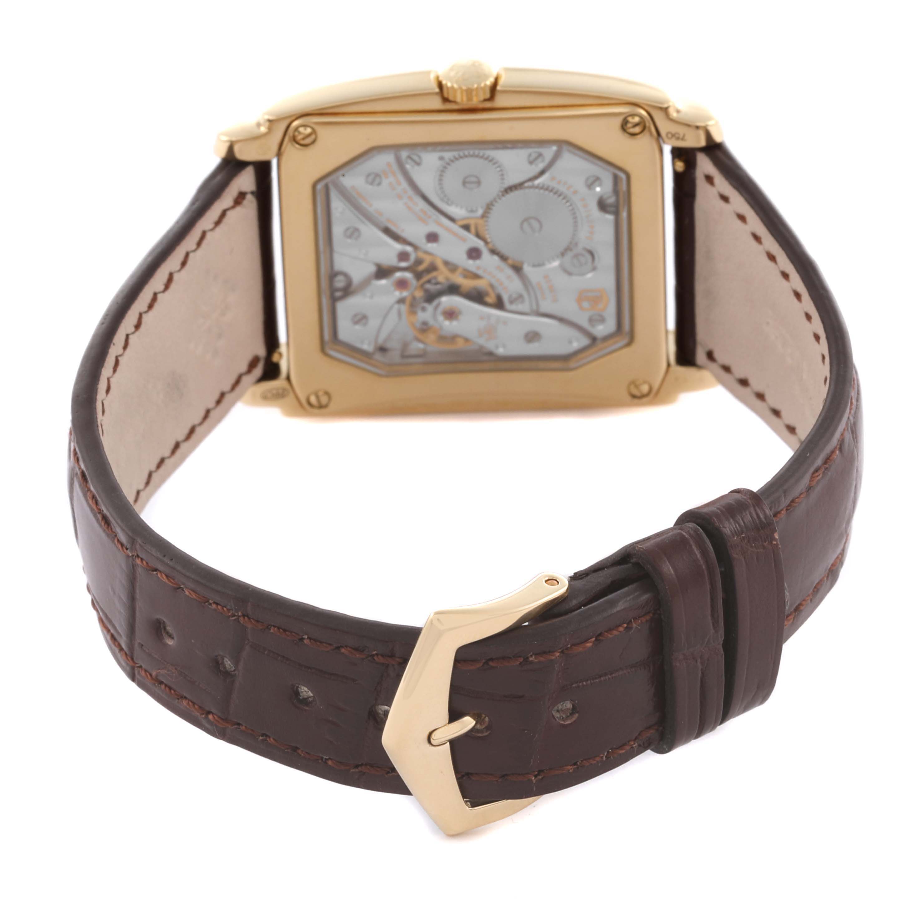 The image shows the back of a Patek Philippe Gondolo 5124J Men's Yellow Gold Silver Dial 5124J Men's Yellow Gold Silver Dial watch, highlighting its movement and leather strap with a gold buckle.