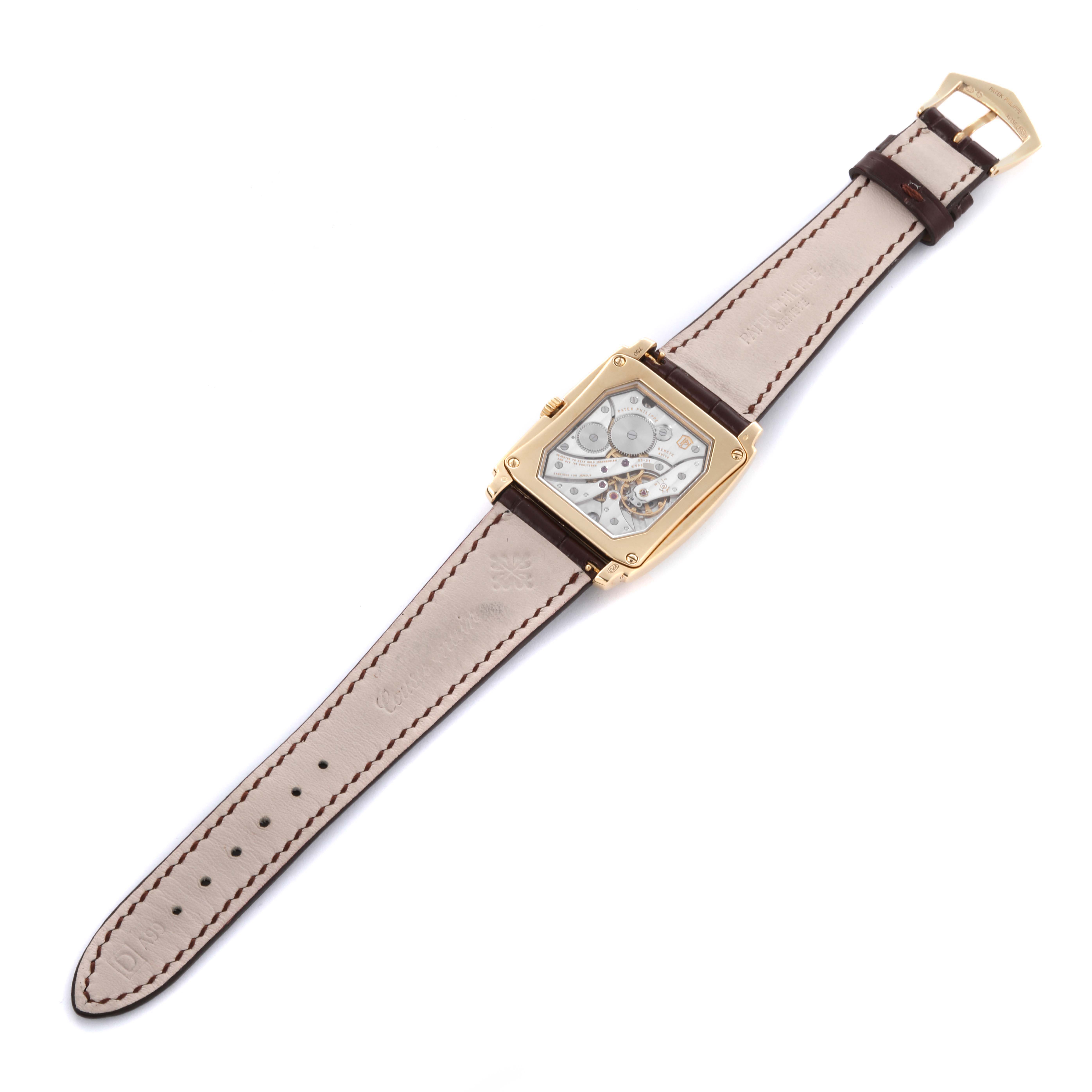 The image shows the Patek Philippe Gondolo 5124J Men's Yellow Gold Silver Dial 5124J Men's Yellow Gold Silver Dial model from the backside, highlighting the watch's movement and leather strap.