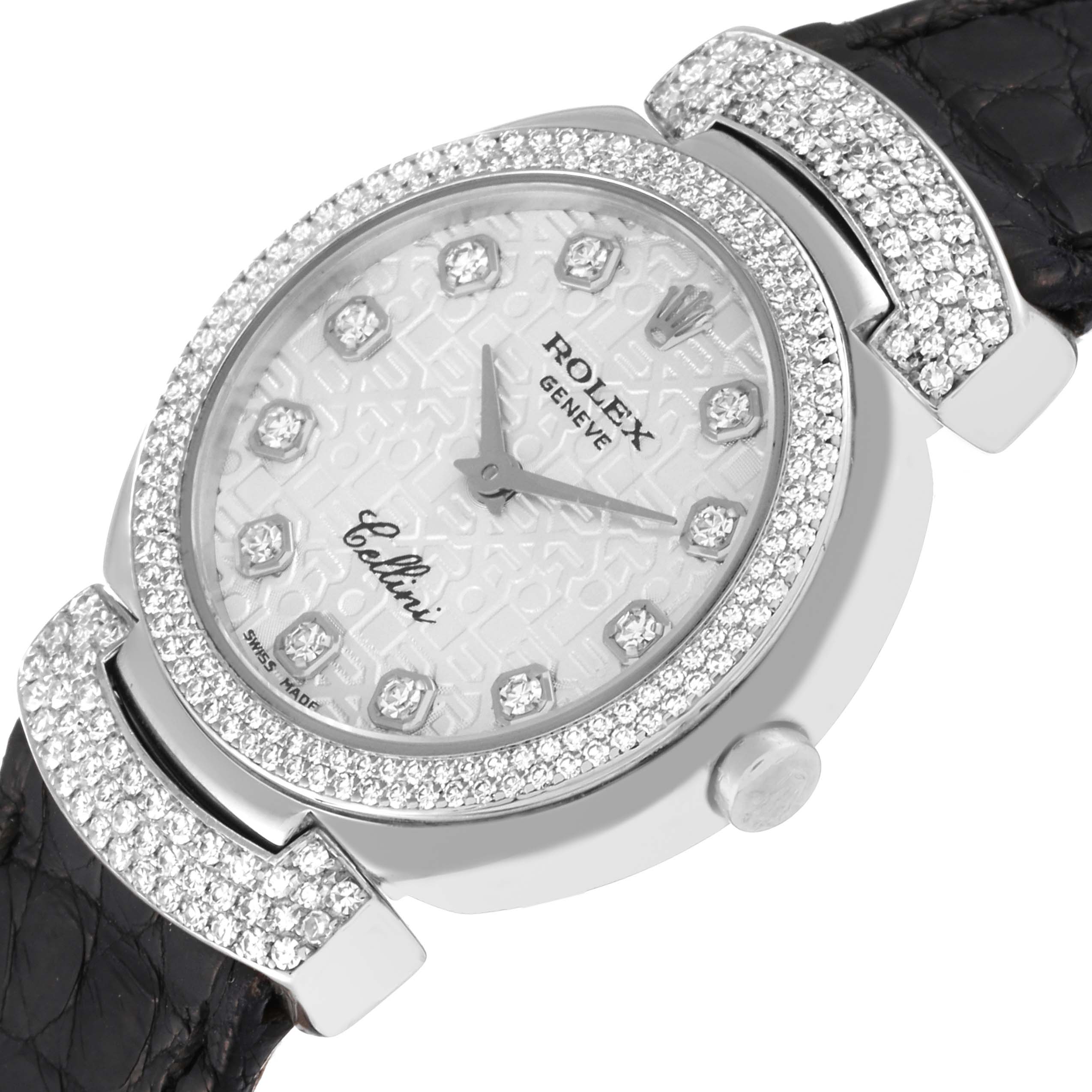 The photo shows a close-up of the Rolex Cellini 6673 Women's White Gold Silver Dial 6673 Women's White Gold Silver Dial watch face, crown, bejeweled bezel, and leather strap from an angled perspective.
