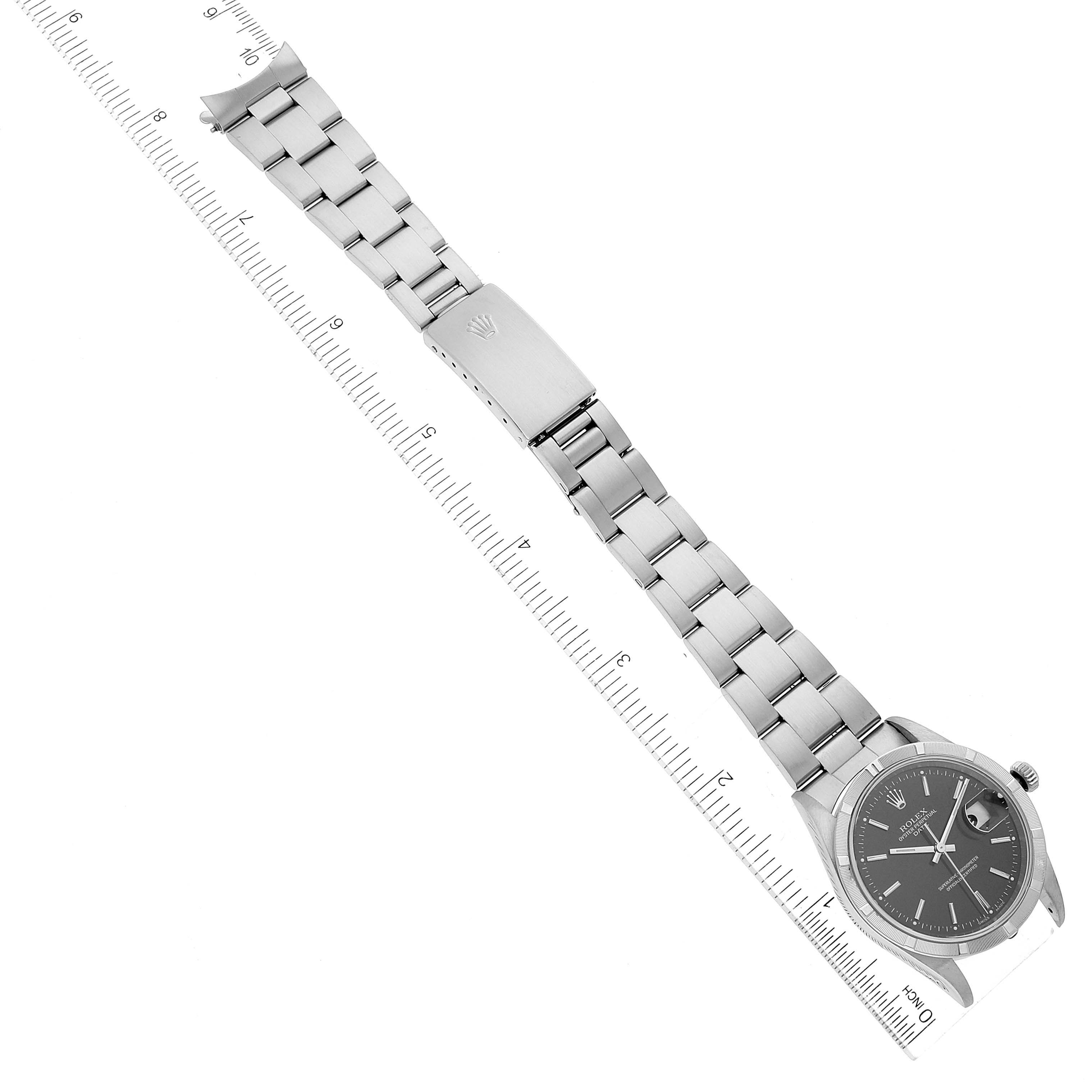This image shows the Rolex Date 15210 Men
s Stainless Steel Black Dial 15210 Men
s Stainless Steel Black Dial model watch, displaying the entire face and bracelet, with a ruler for scale measurement.