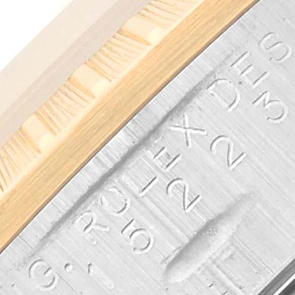 The image shows a close-up of the bezel and serial number engraving on a Rolex Date 15223 Men's Steel and Gold (two tone) White Dial 15223 Men's Steel and Gold (two tone) White Dial model watch.