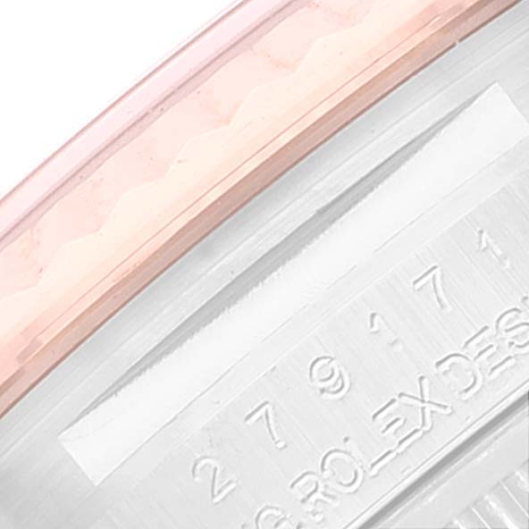 This close-up image of a Rolex Datejust 279171 Women's Steel and Gold (two tone) Blue Dial 279171 Women's Steel and Gold (two tone) Blue Dial watch shows part of the bezel and the engraved serial number on the side.