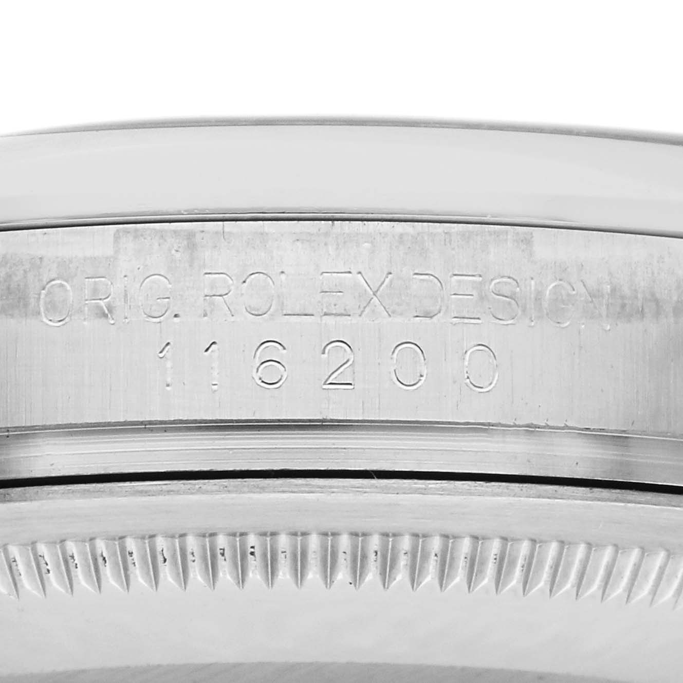 The image shows a close-up of the model number engraving on the side of the Rolex Datejust 116200 Men's Stainless Steel Black Dial 116200 Men's Stainless Steel Black Dial's case.