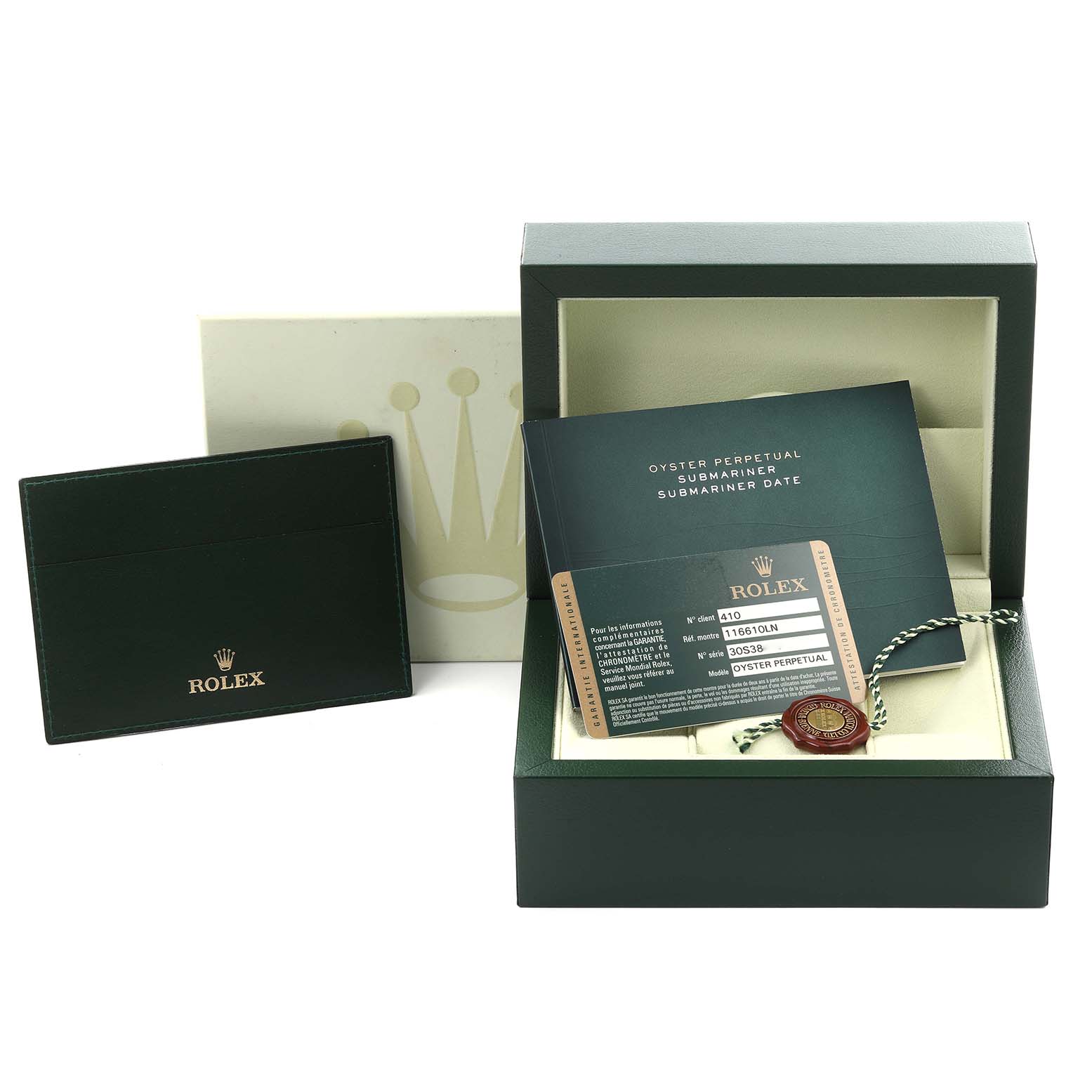 The image shows a Rolex Submariner mid-size watch box, certificate, and card from a front angle.
