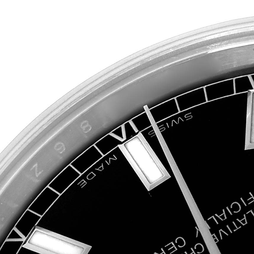 The image shows a close-up of the dial and hands of a mid-size Rolex watch at an oblique angle.