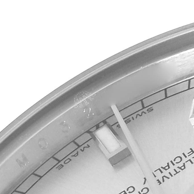 The image shows the upper left portion of a Rolex Mid-Size 178274 Women's Stainless Steel Silver Dial 178274 Women's Stainless Steel Silver Dial watch face, including the bezel, dial, and part of a hand.