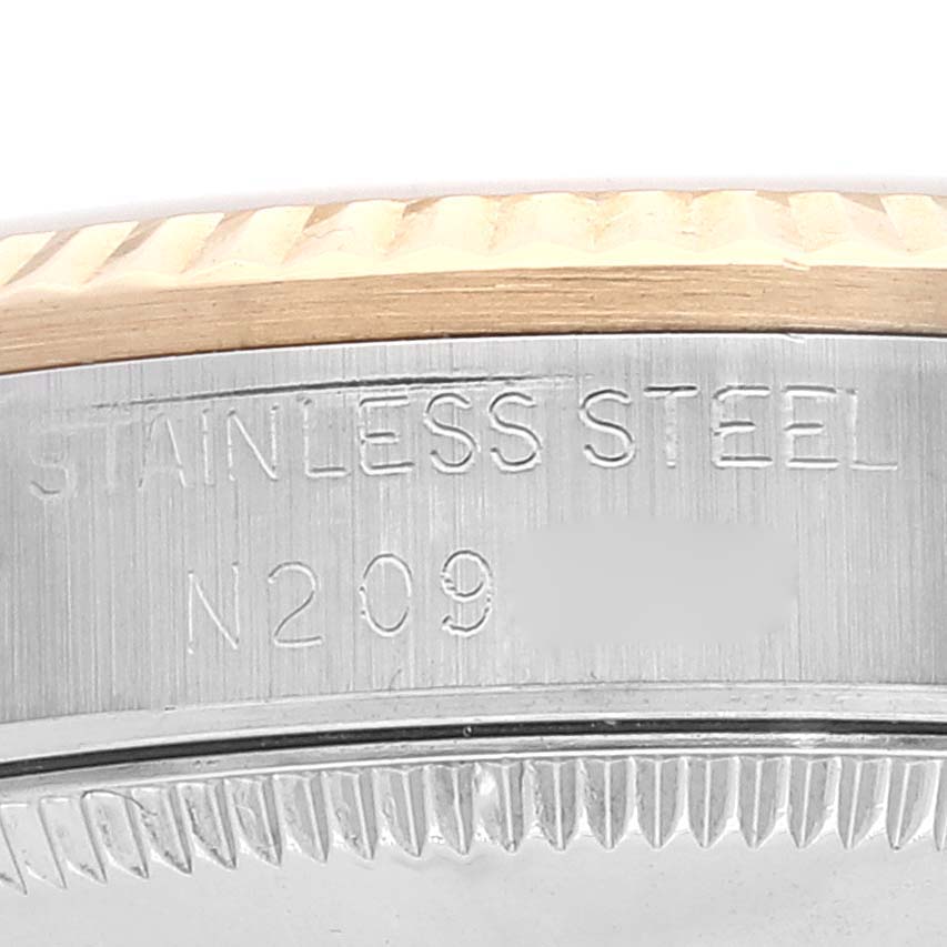 This image shows a close-up of the side engravings on a stainless steel bezel of a Rolex Mid-Size 68273 Women
s Steel and Gold (two tone) Champagne Dial 68273 Women
s Steel and Gold (two tone) Champagne Dial watch.