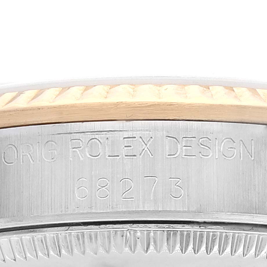 This image shows the side engraving of a Rolex Mid-Size 68273 Women
s Steel and Gold (two tone) Champagne Dial 68273 Women
s Steel and Gold (two tone) Champagne Dial watch model 68273, highlighting the model number and the fluted bezel.