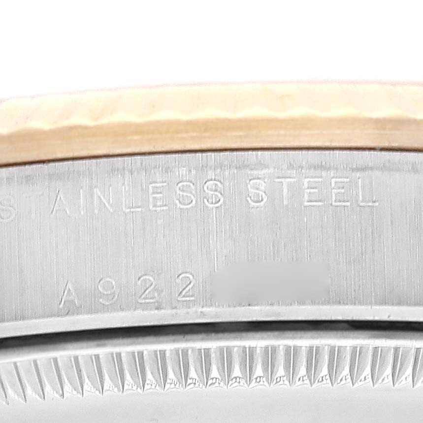 The image shows a close-up of the bezel and serial number on the stainless steel case of a mid-size Rolex watch.