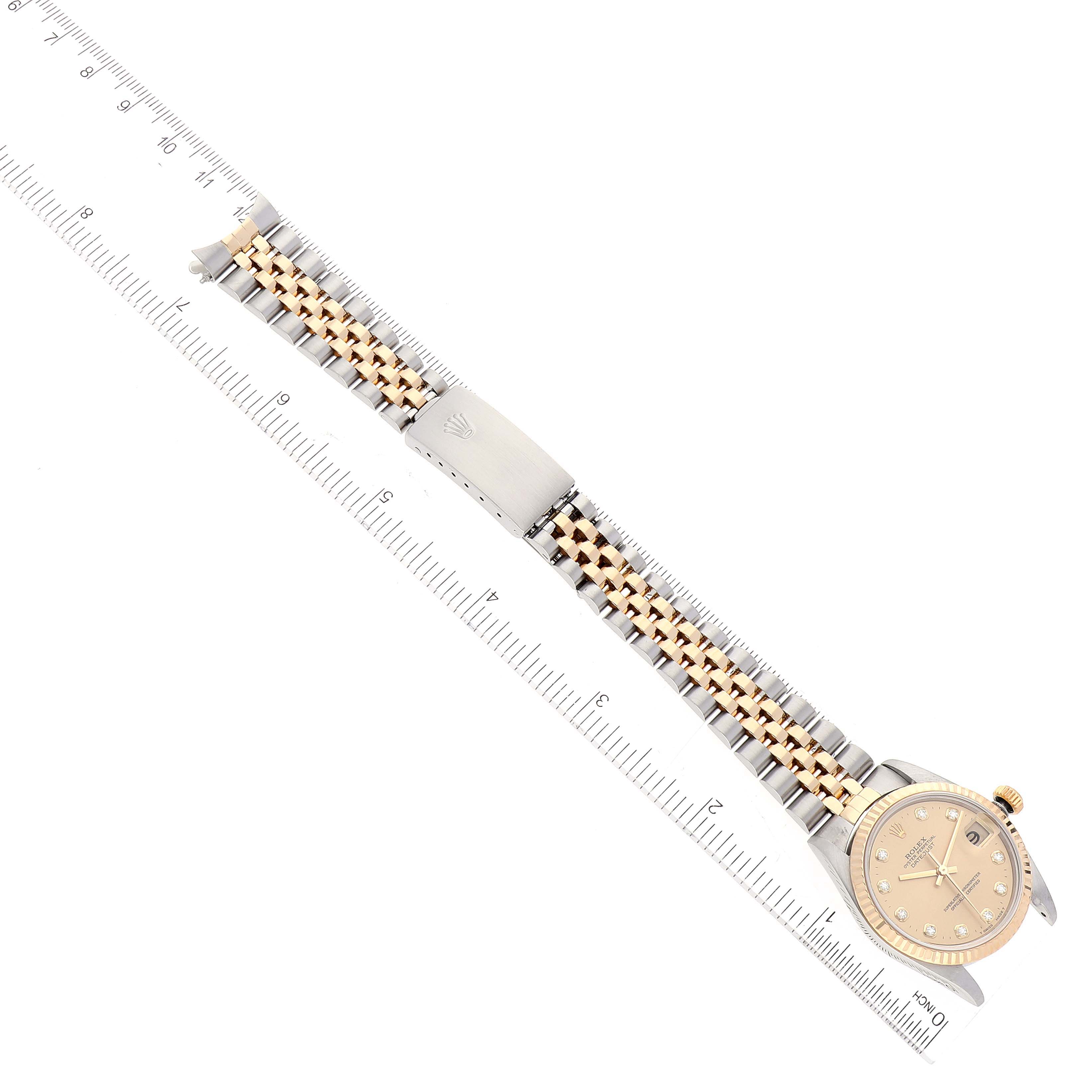 This image shows a top-down view of a Rolex Mid-Size 78273 Women
s Steel and Gold (two tone) Champagne Dial 78273 Women
s Steel and Gold (two tone) Champagne Dial watch, displaying the watch face, bracelet, and clasp.