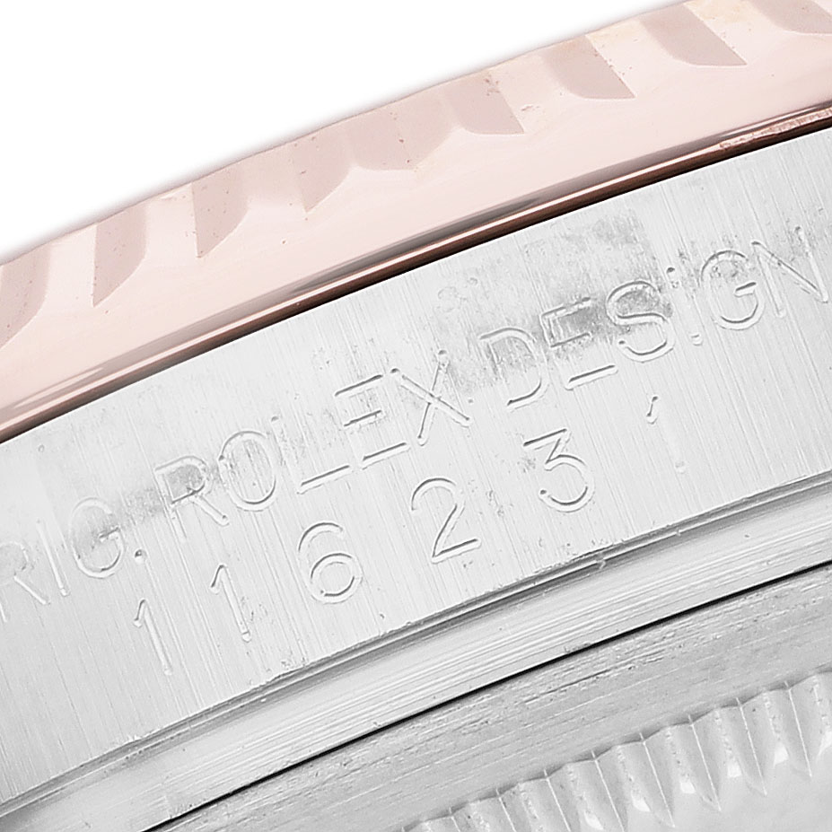 The image shows a close-up of the engraved edge and bezel of a Rolex Datejust 116231 Men's Steel and Gold (two tone) Pink Dial watch.