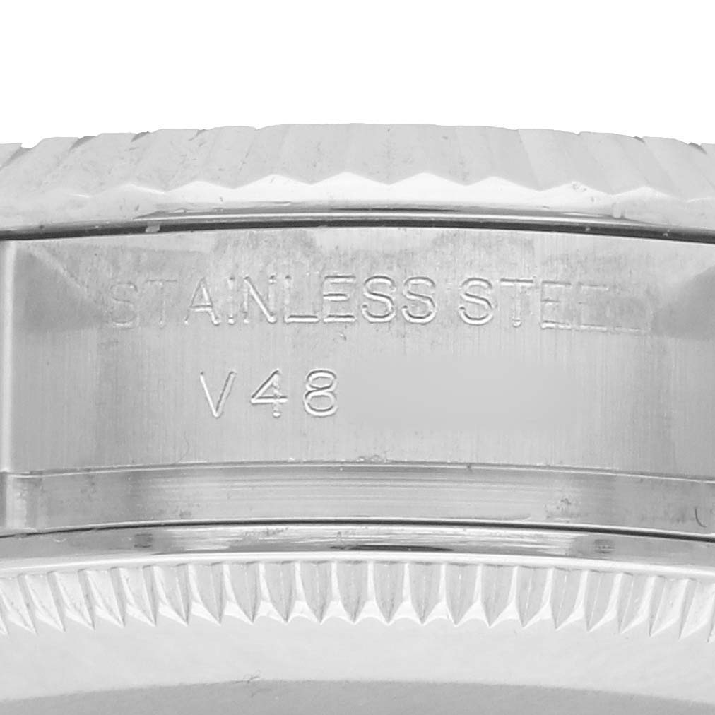 The image shows a close-up of the side of a Rolex Datejust 179174 Women's Stainless Steel Blue Dial watch, highlighting the stainless steel engraving on the case.