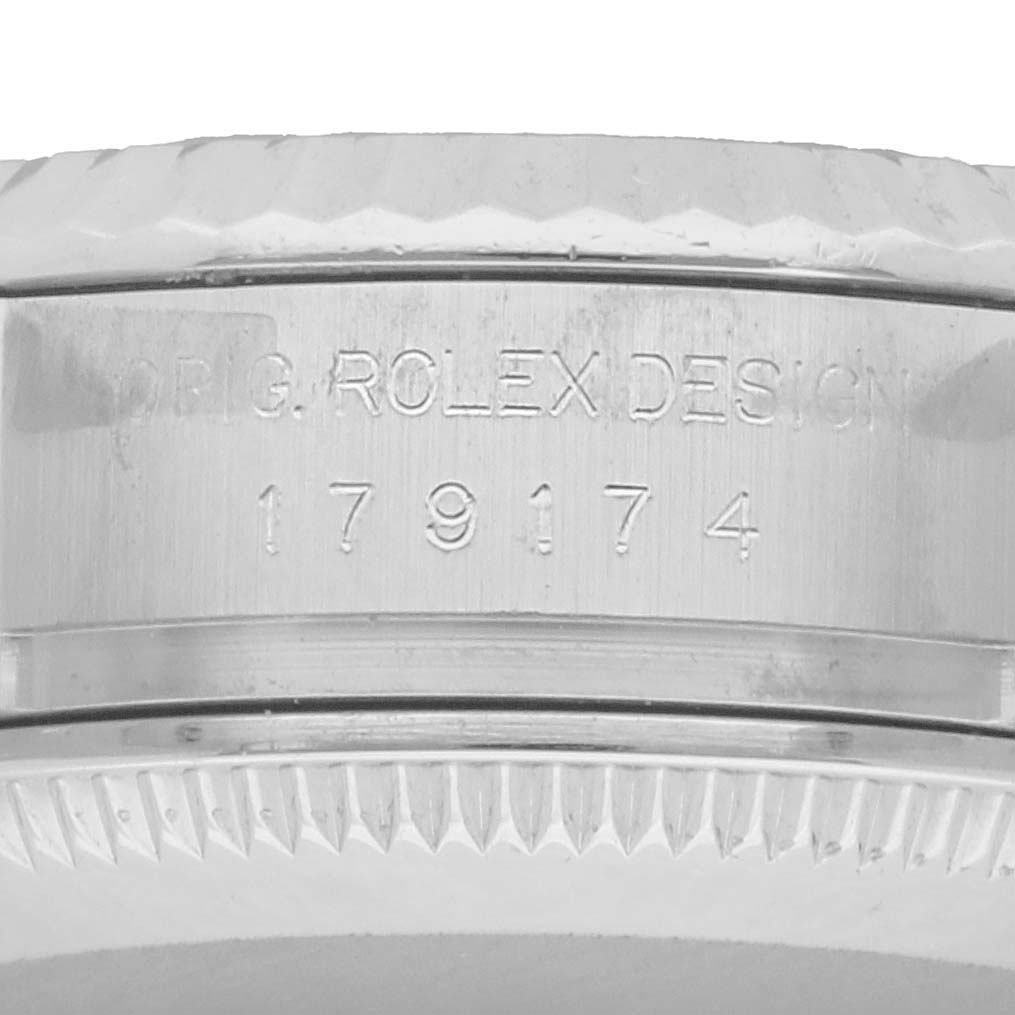 The image shows a close-up of the case side of a Rolex Datejust 179174 Women's Stainless Steel Blue Dial, highlighting the design engraving and model number.