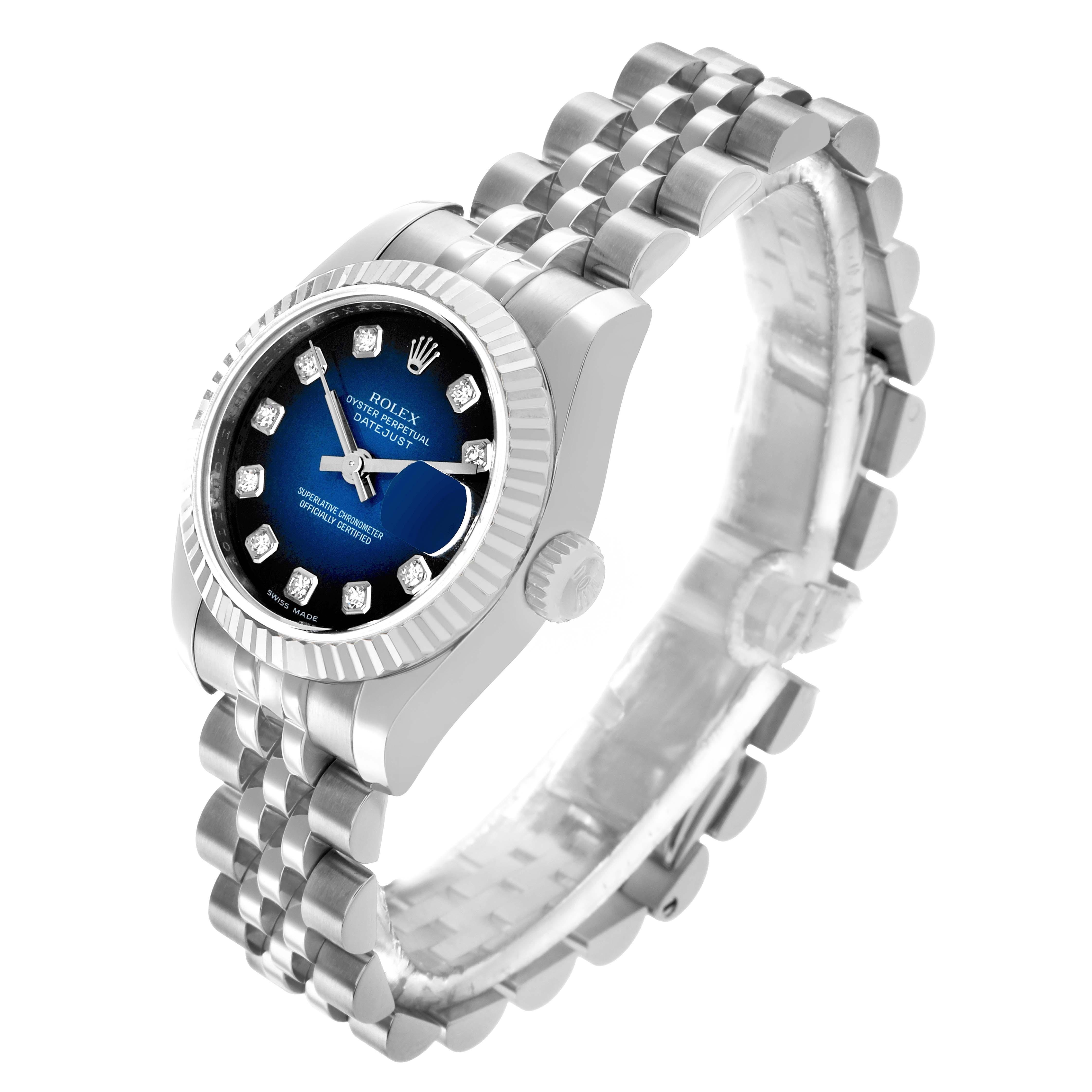 The Rolex Datejust 179174 Women's Stainless Steel Blue Dial watch is shown at a three-quarter angle, highlighting its blue dial, fluted bezel, and Jubilee bracelet.