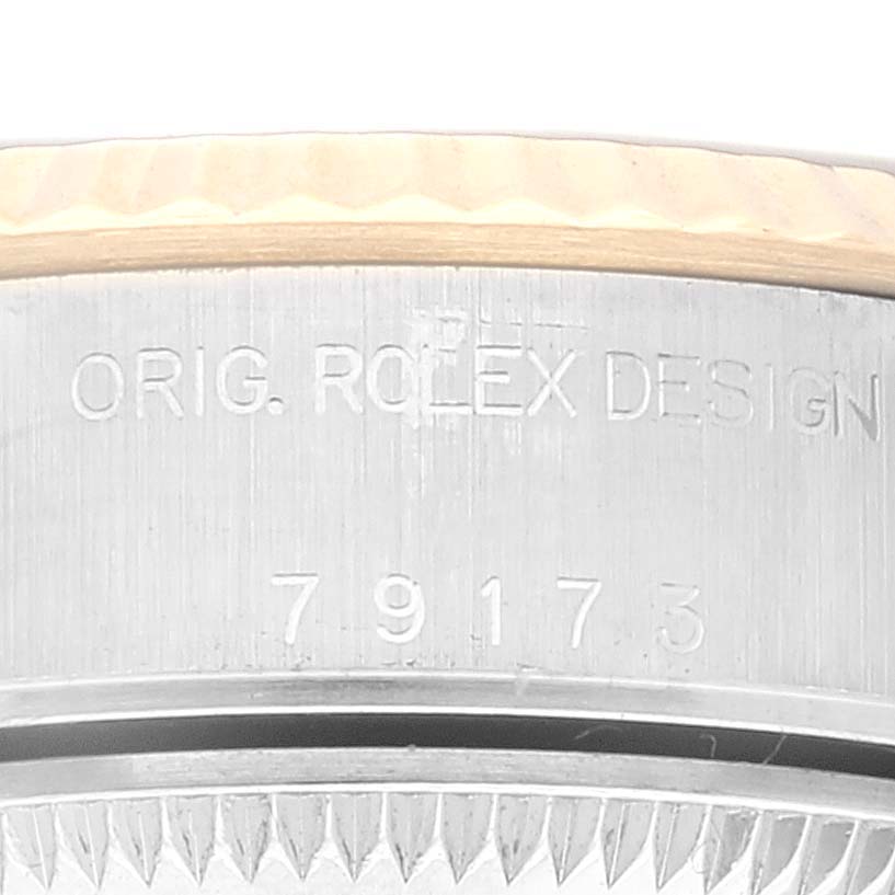 The image shows a close-up of the serial number and "Orig. Rolex Design" engraving on the side of a Rolex Datejust 79173 Women's Steel and Gold (two tone) Champagne Dial 79173 Women's Steel and Gold (two tone) Champagne Dial watch case.