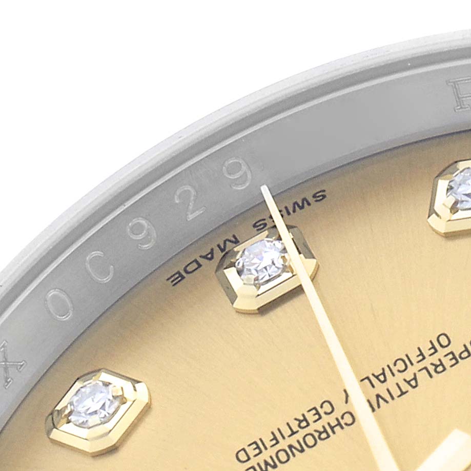 The image shows a close-up of the Rolex Datejust 116233 Men
s Steel and Gold (two tone) Champagne Dial watch dial focusing on the diamond hour markers and part of the bezel.