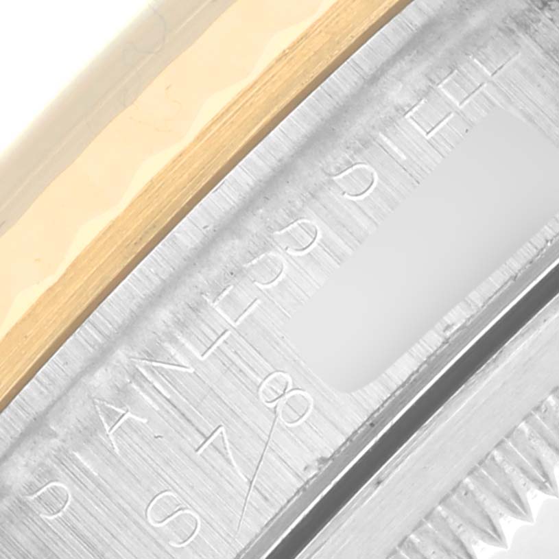 The image shows a close-up of the engraved inner bezel of a Rolex Datejust 16233 Men
s Steel and Gold (two tone) White Dial 16233 Men
s Steel and Gold (two tone) White Dial watch, highlighting the "Stainless Steel" text.
