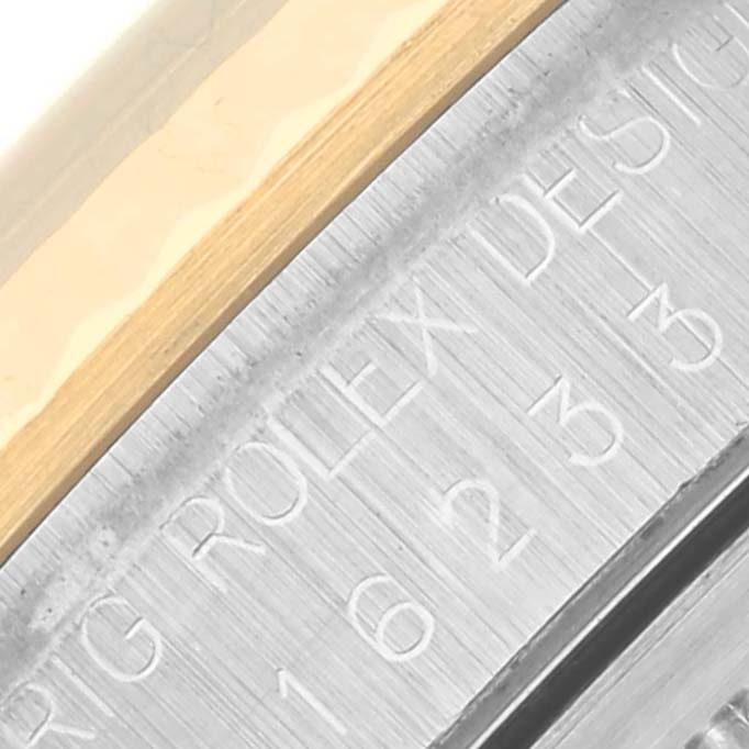 The image shows a close-up of the case side of a Rolex Datejust 16233 Men
s Steel and Gold (two tone) White Dial 16233 Men
s Steel and Gold (two tone) White Dial, highlighting the engraved serial number.