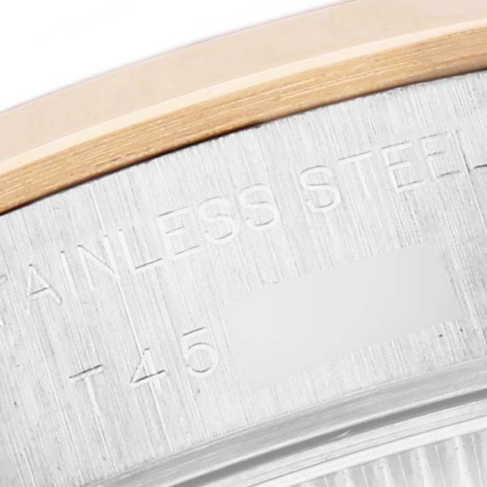 The image shows a close-up of the Rolex Datejust 69163 Women's Steel and Gold (two tone) Grey Dial 69163 Women's Steel and Gold (two tone) Grey Dial case edge with engravings, including "STAINLESS STEEL."