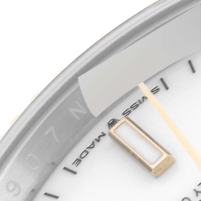 This close-up of a Rolex Datejust 126233 Men's Steel and Gold (two tone) White Dial 126233 Men's Steel and Gold (two tone) White Dial watch shows part of the dial with the "SWISS MADE" text and partial hour markers.