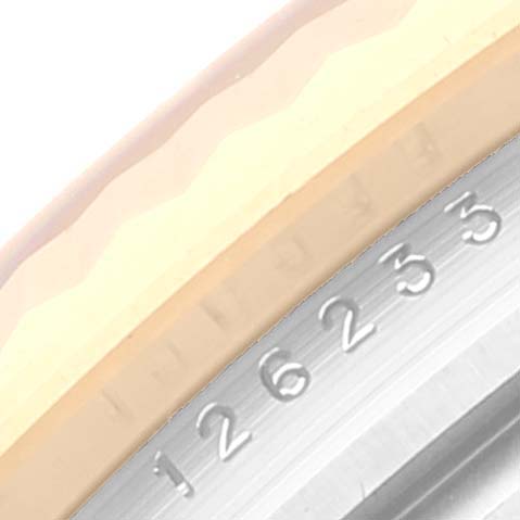The image shows a close-up view of the serial number engraving on the bezel and rehaut of a Rolex Datejust 126233 Men's Steel and Gold (two tone) White Dial 126233 Men's Steel and Gold (two tone) White Dial watch.