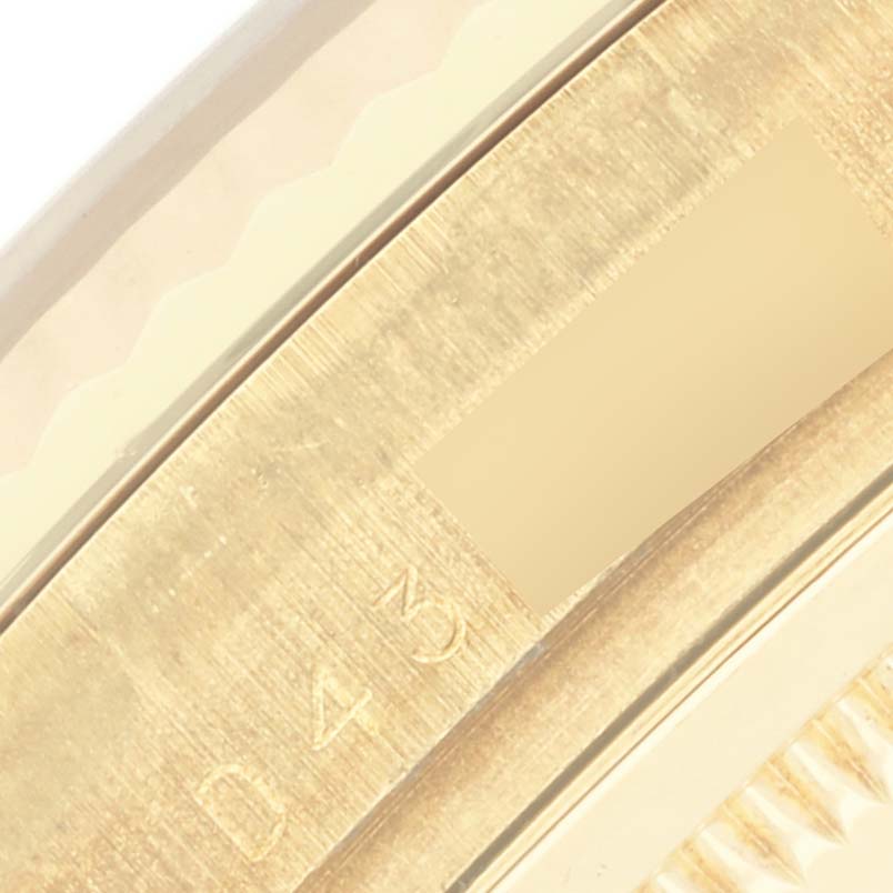 The image shows a close-up of the edge of the Rolex Datejust 116238 Men's Yellow Gold Mother of Pearl Dial 116238 Men's Yellow Gold Mother of Pearl Dial watch, highlighting the fluted bezel detail.