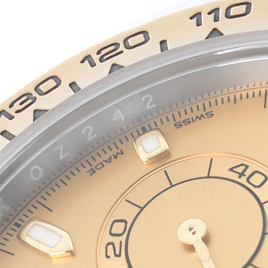 The image shows a close-up of the bezel, dial, and part of the subdial of a Rolex Daytona 116503 Men
s Steel and Gold (two tone) Champagne Dial 116503 Men
s Steel and Gold (two tone) Champagne Dial watch at an angle.