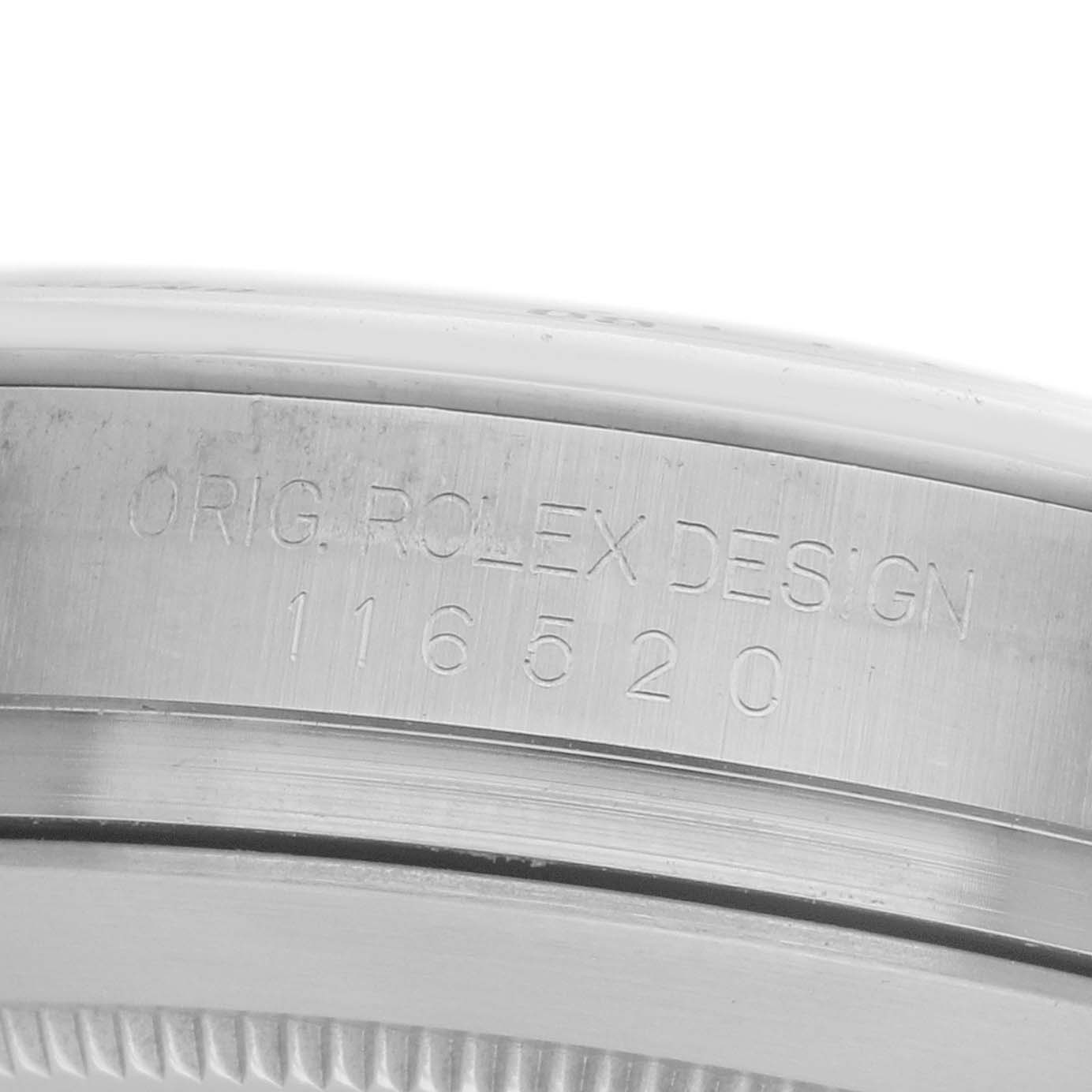The image shows the engraved side of a Rolex Daytona 116520 Men
s Stainless Steel White Dial watch case, highlighting the model number.