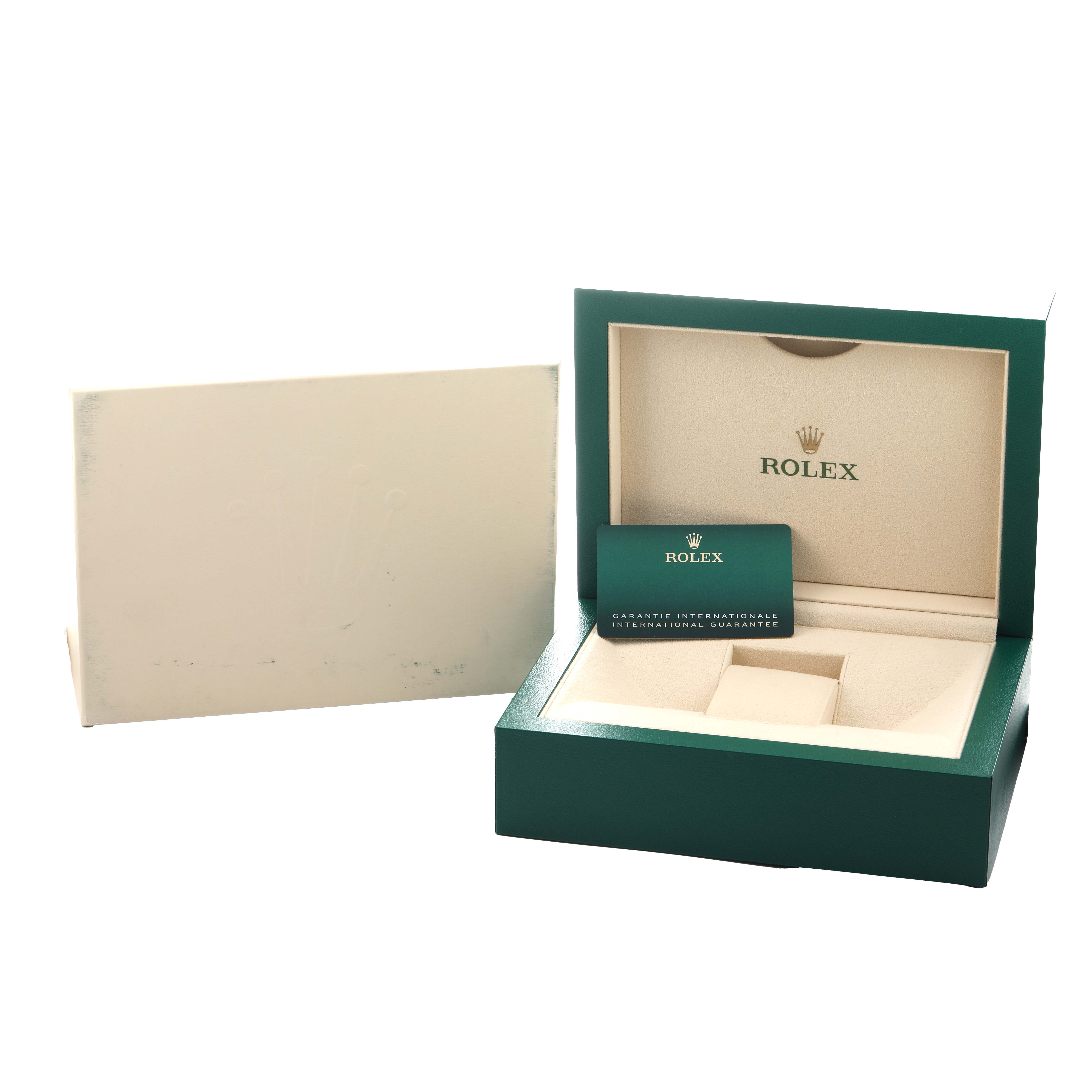 The image shows an open Rolex Daytona 116519 Men
s White Gold Black Dial watch box and an international guarantee card, viewed from the front.