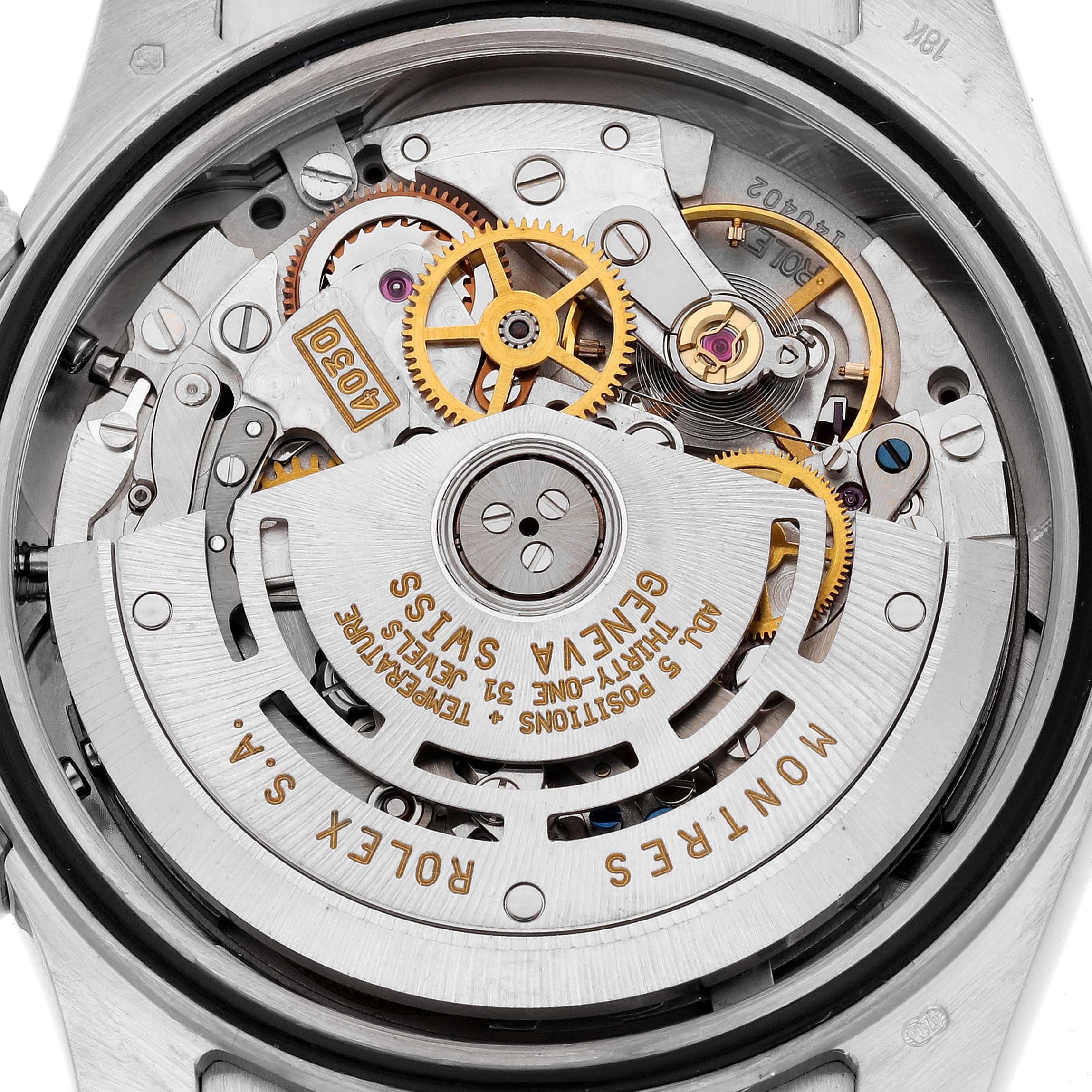 The image shows the intricate inner movement of a Rolex Daytona 16519NG Men's White Gold Mother of Pearl Dial 16519NG Men's White Gold Mother of Pearl Dial watch from a back angle, revealing gears and the rotor.