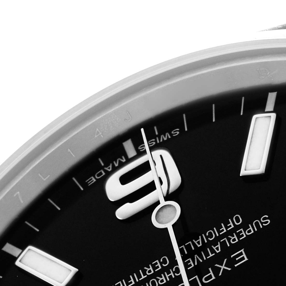 The image shows a close-up of the dial of a Rolex Explorer 214270 Men
s Stainless Steel Black Dial, focusing on the numeral 9, indices, and "Swiss Made" text.