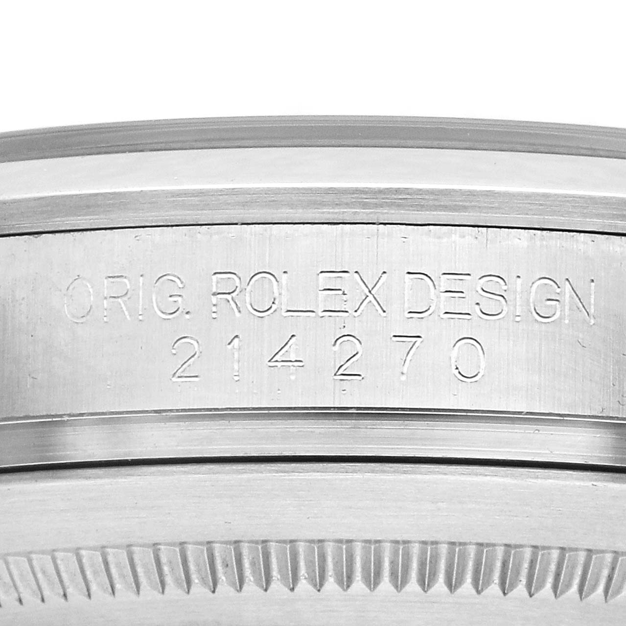The image shows the engraved side of a Rolex Explorer 214270 Men
s Stainless Steel Black Dial watch case, displaying "ORIG. ROLEX DESIGN 214270."