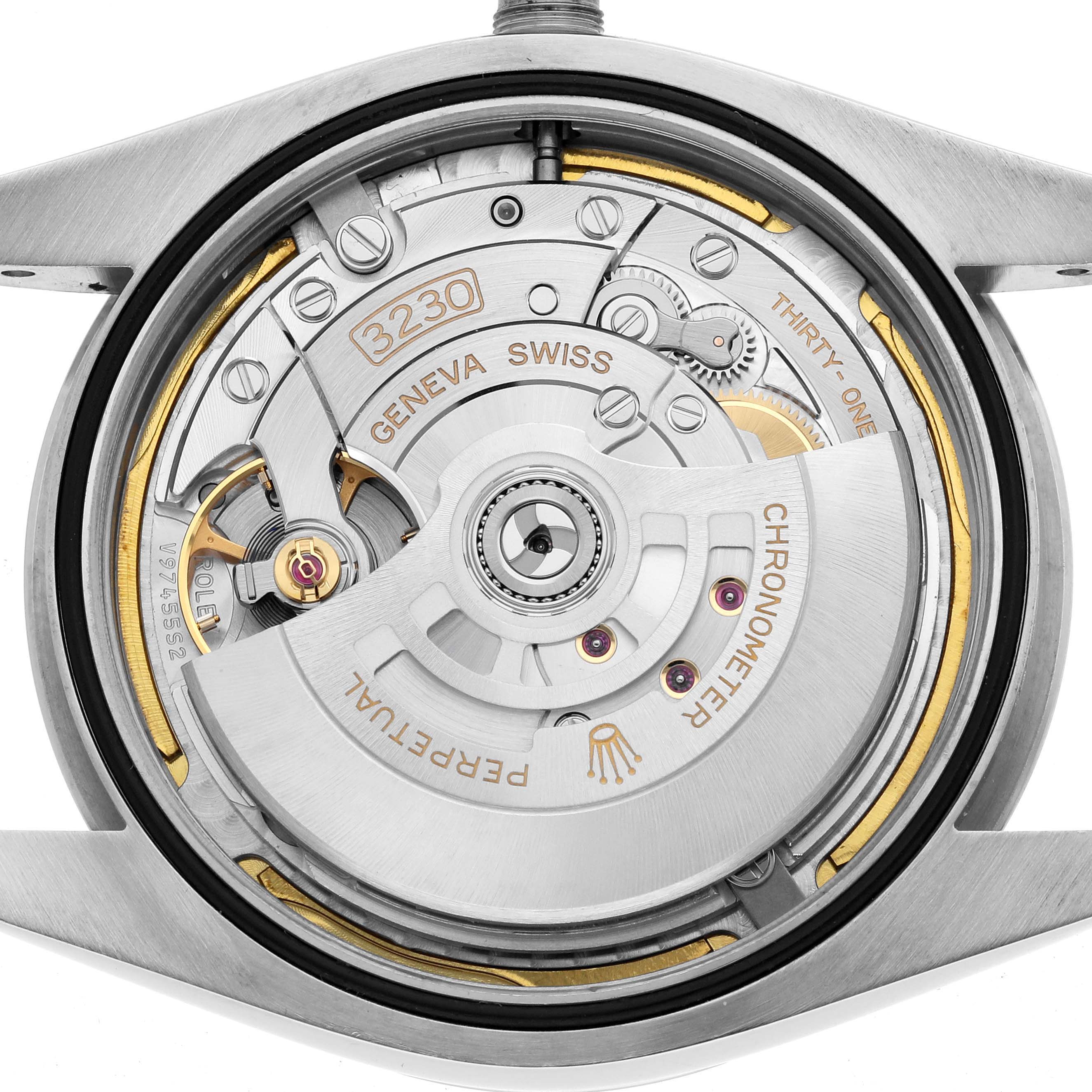 The image shows the movement of a Rolex Oyster Perpetual 124300 Men
s Stainless Steel Green Dial watch from a rear angle, highlighting the rotor and mechanism.