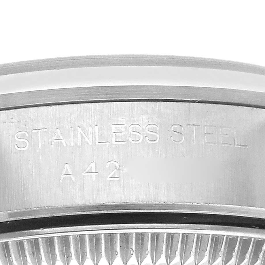 The image shows a close-up of the side of a Rolex Oyster Perpetual 76080 Women's Stainless Steel Pink Dial 76080 Women's Stainless Steel Pink Dial watch, highlighting the stainless steel case engraving.