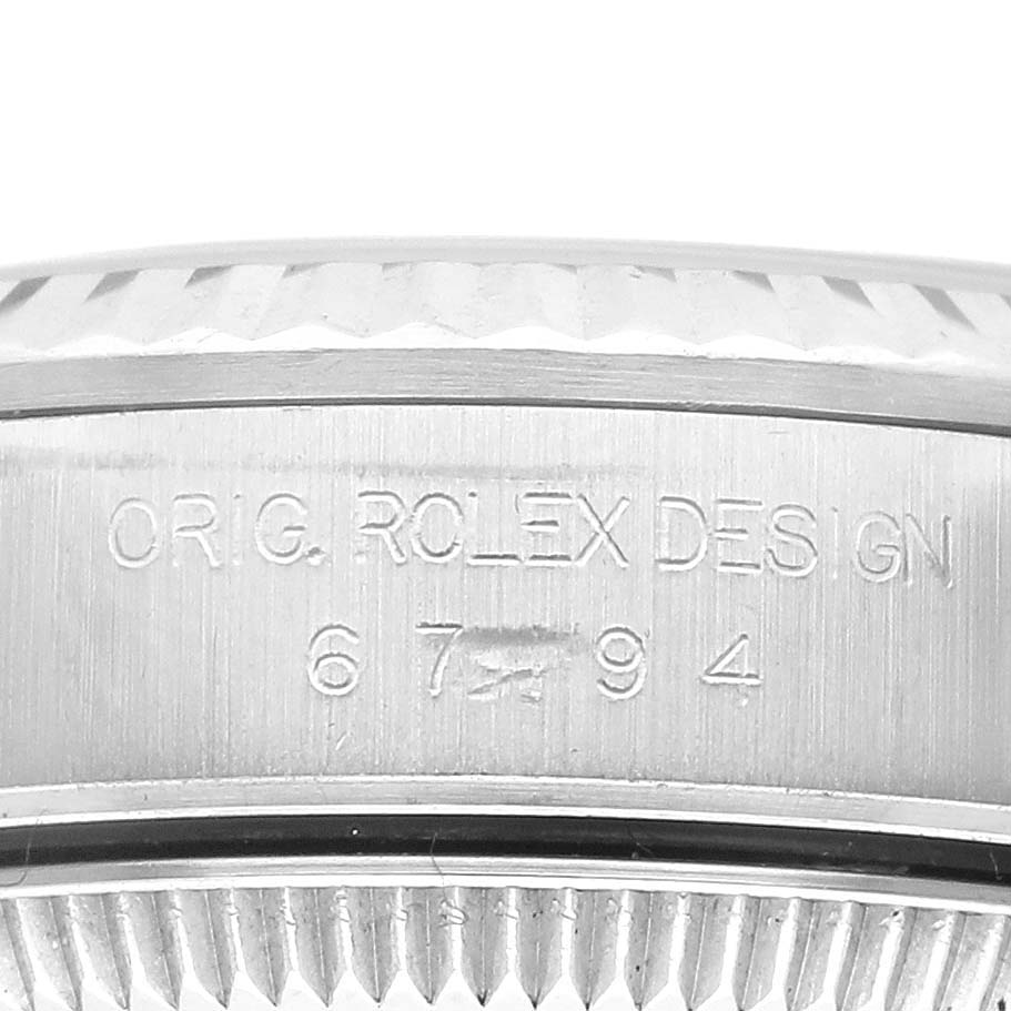 This image shows the side profile of the Rolex Oyster Perpetual 67194 Women's Stainless Steel Black Dial 67194 Women's Stainless Steel Black Dial case with engraving details.
