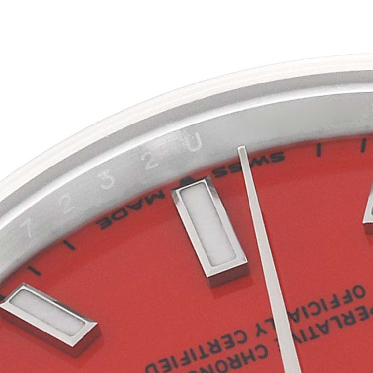 The image shows a close-up of the red dial and part of the bezel of a mid-size Rolex watch.