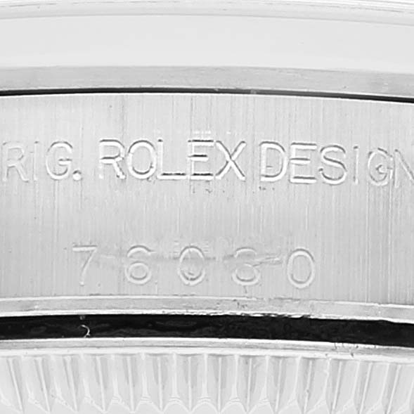 The image shows a close-up view of the casing edge with engraved text on a Rolex Oyster Perpetual 76080 Women
s Stainless Steel Pink Dial 76080 Women
s Stainless Steel Pink Dial watch.