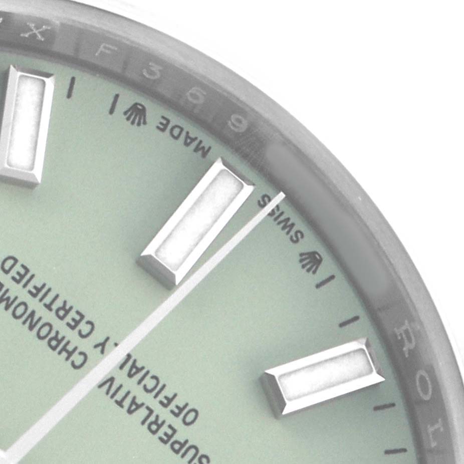 The image shows a close-up of the dial of a Rolex Oyster Perpetual 276200 Women
s Stainless Steel Green Dial, highlighting the hour markers and part of the logo.