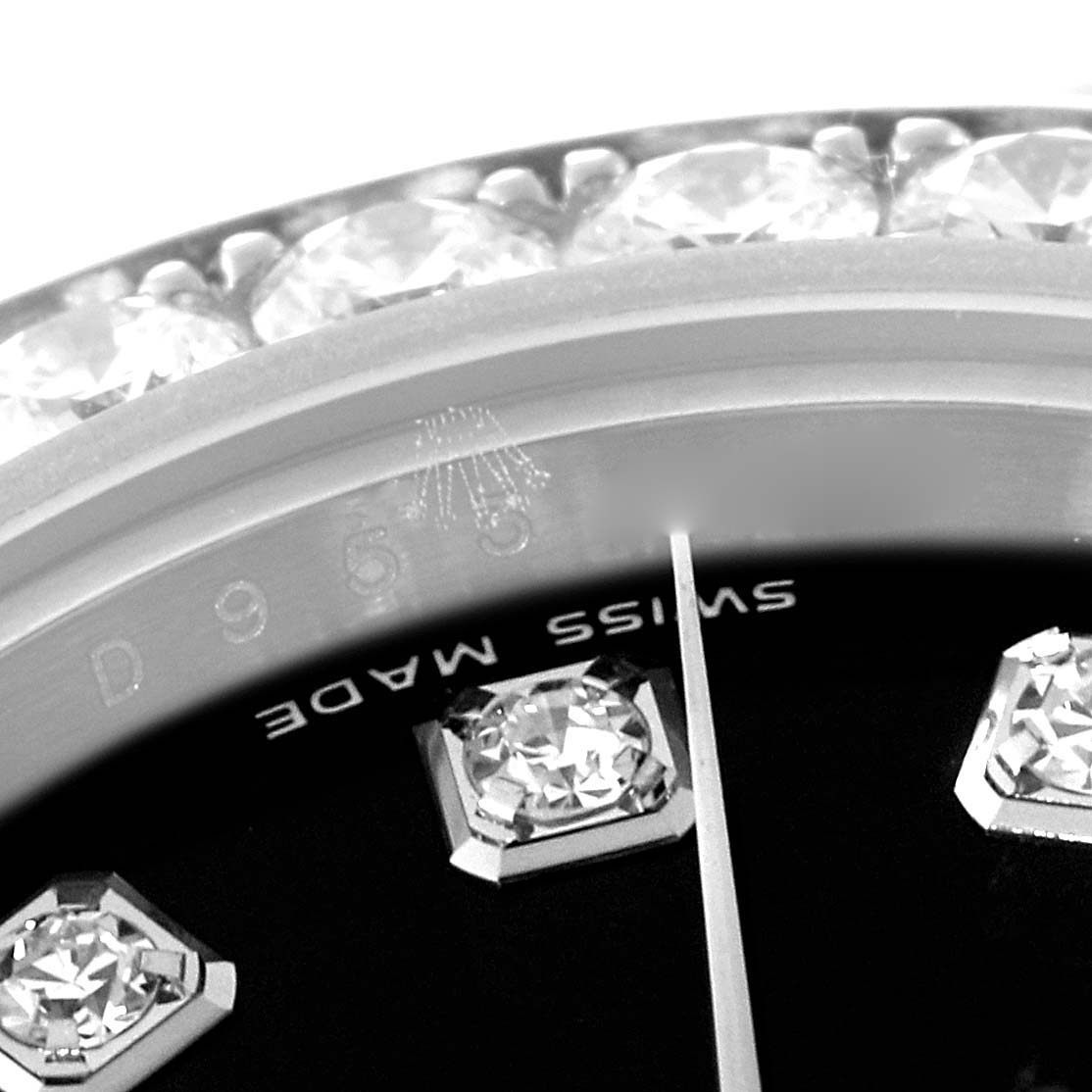 The close-up shot of the Rolex Pearlmaster 80299 Women's White Gold Black Dial 80299 Women's White Gold Black Dial watch shows a portion of the bezel, dial, diamonds, and part of the "Swiss Made" label.