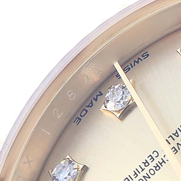 This image shows a close-up of the dial from a Rolex President 279178 Women
s Yellow Gold Champagne Dial watch, highlighting its diamond hour markers and "Swiss Made" text.